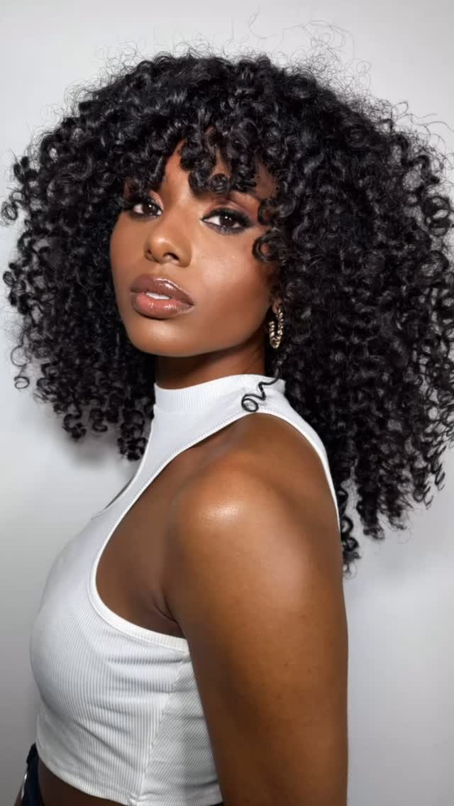 Rounded Shoulder-Length Coil Cut with Eye-Grazing Fringe
