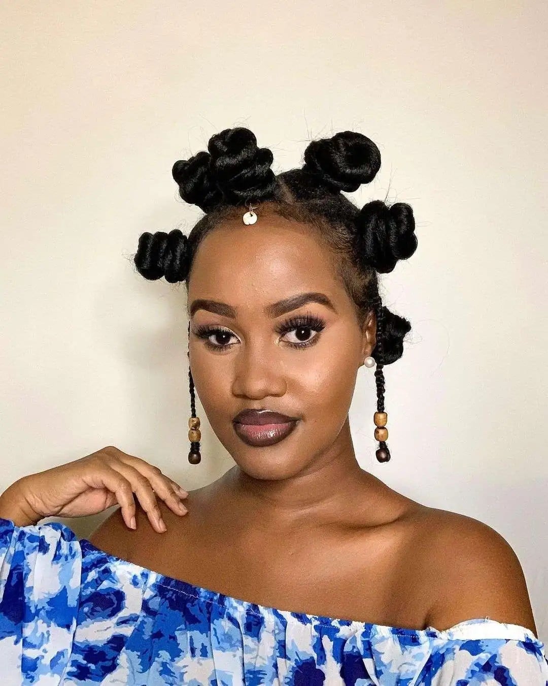 Sculpted Coily Knot Updo with Cowrie Accent and Beaded Braids