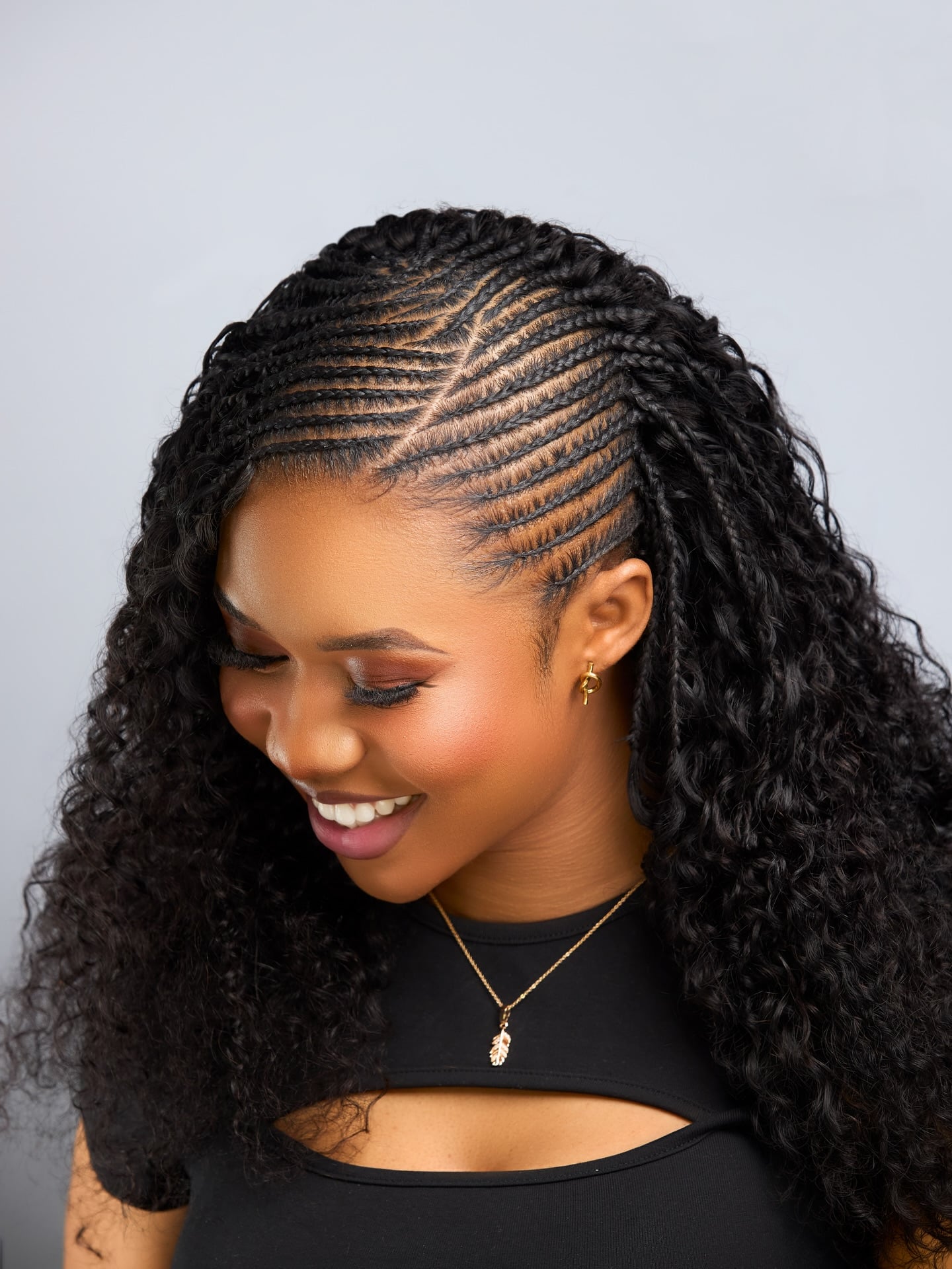Diagonal Feed-In Cornrows Flowing to Voluminous Curly Extensions