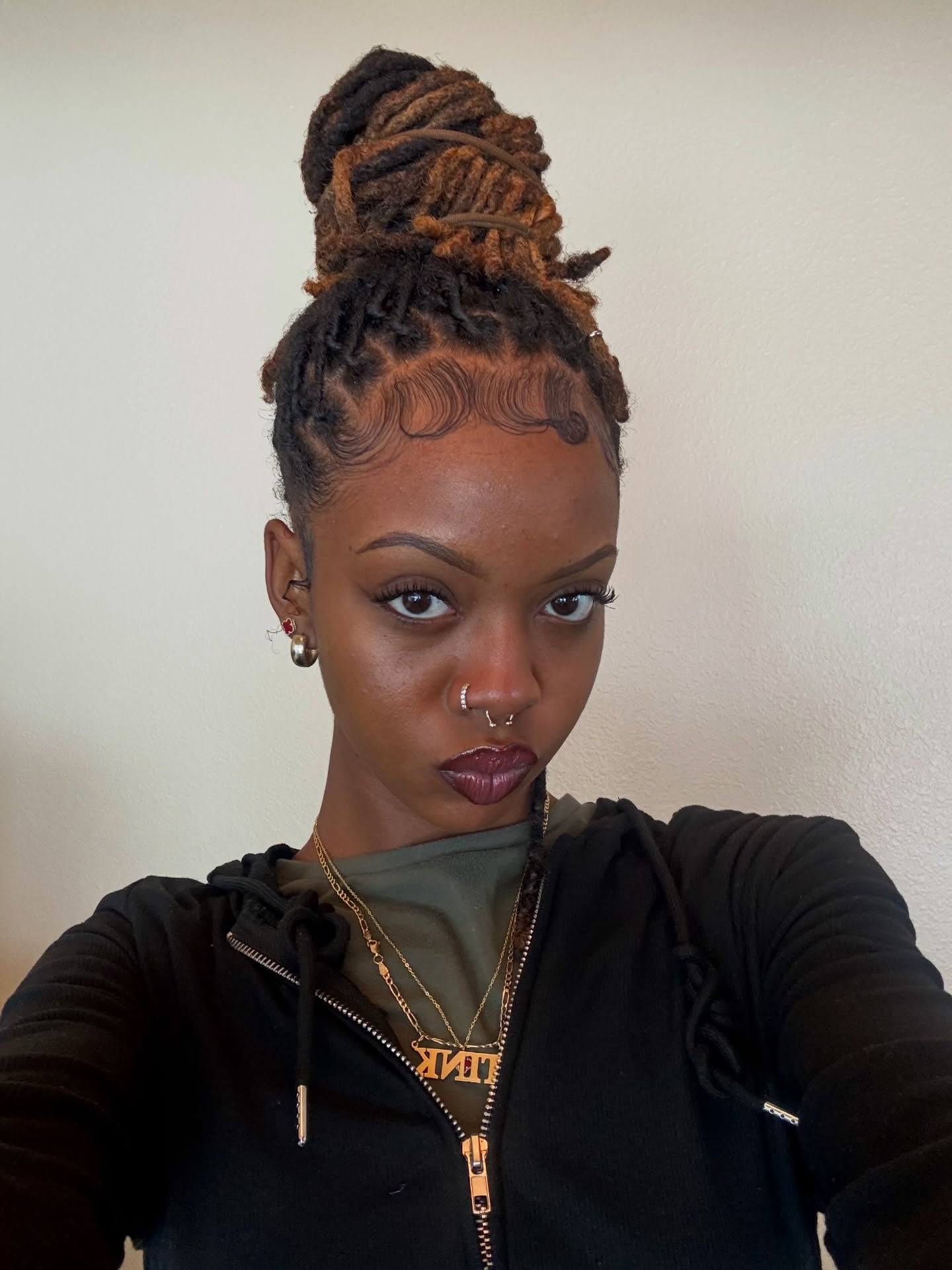 High Twisted Loc Bun with Sculpted Baby Hair and Bronde Tips