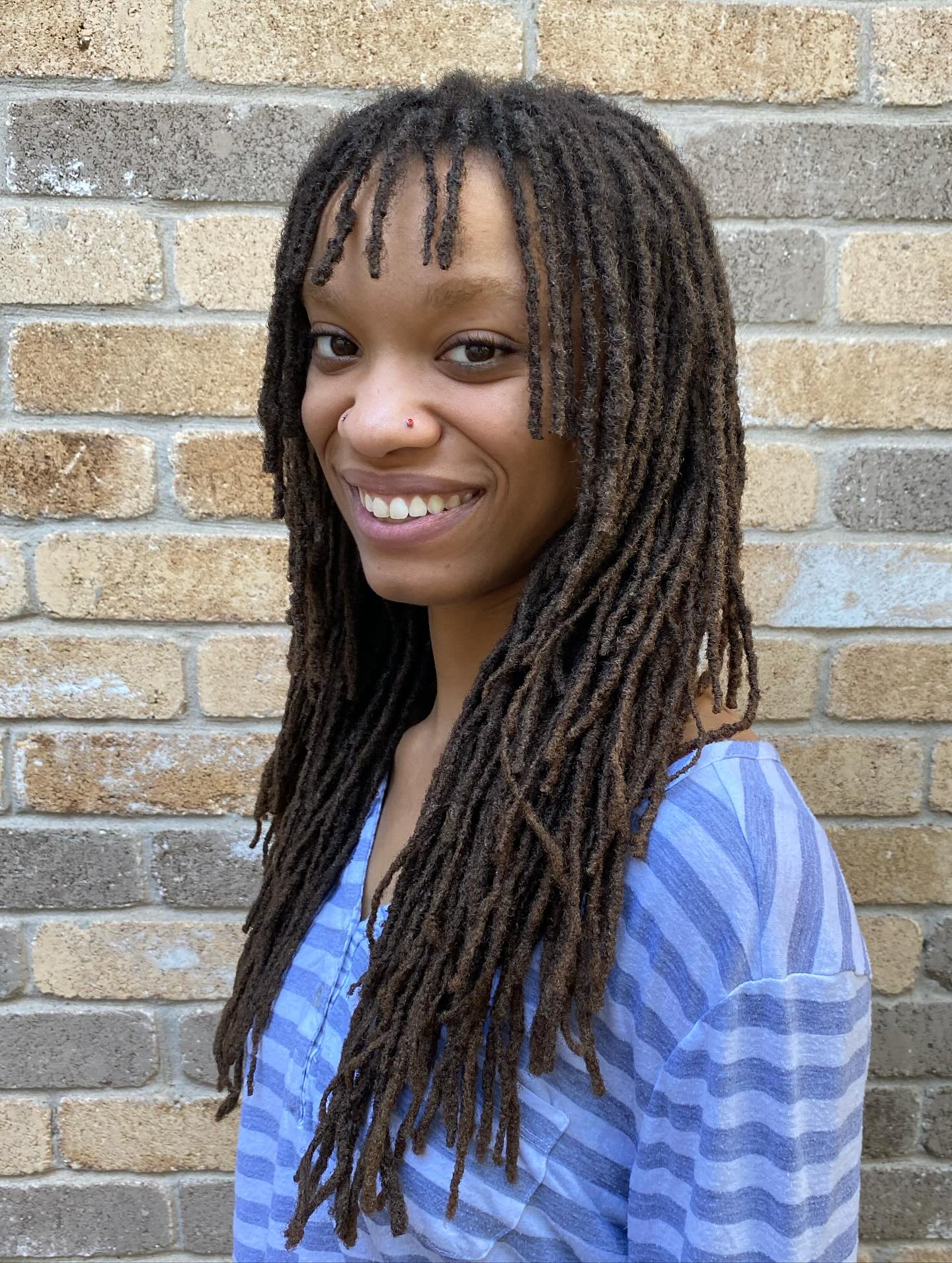 Long Micro Locs with Soft Curtain Bangs and Tapered Ends