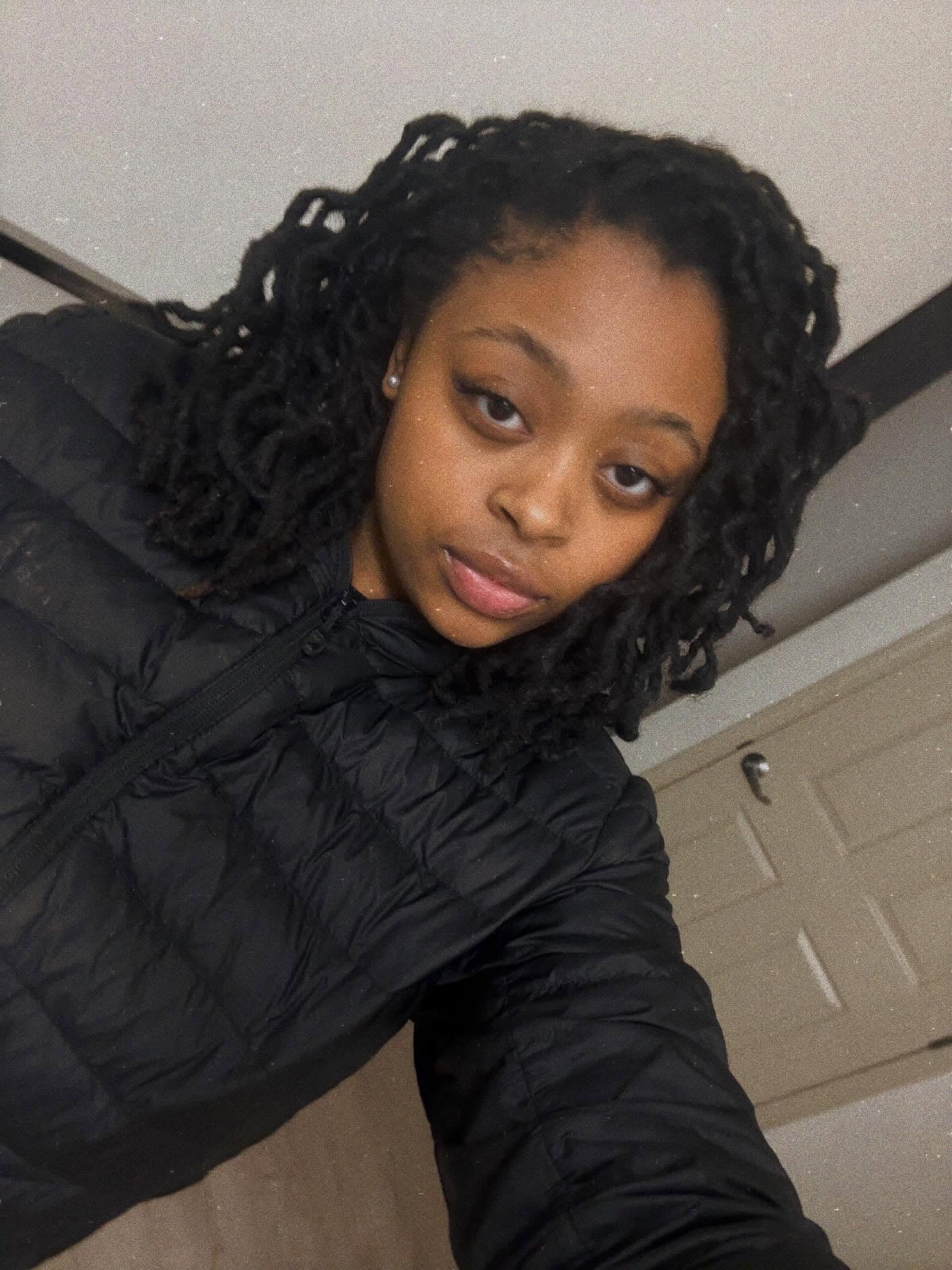 Shoulder-Grazing Interlocked Locs with Natural Temple Taper and Loose Corkscrew Ends