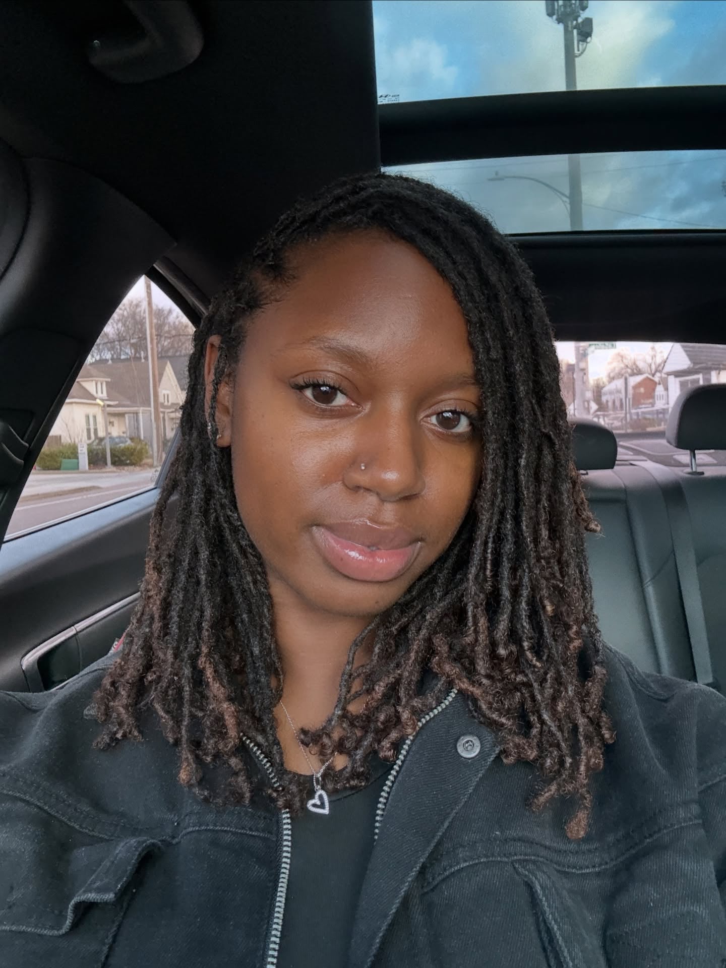 Shoulder-Length Palm-Rolled Locs with Sun-Kissed Tips and Deep Side Part