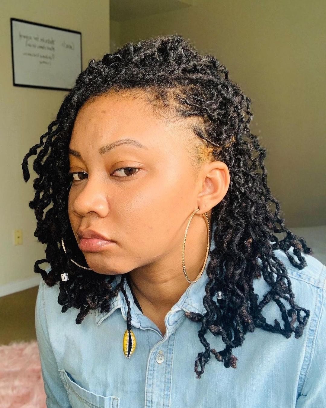 Shoulder-Length Textured Micro Locs with Tapered Temple and Cowrie Accent