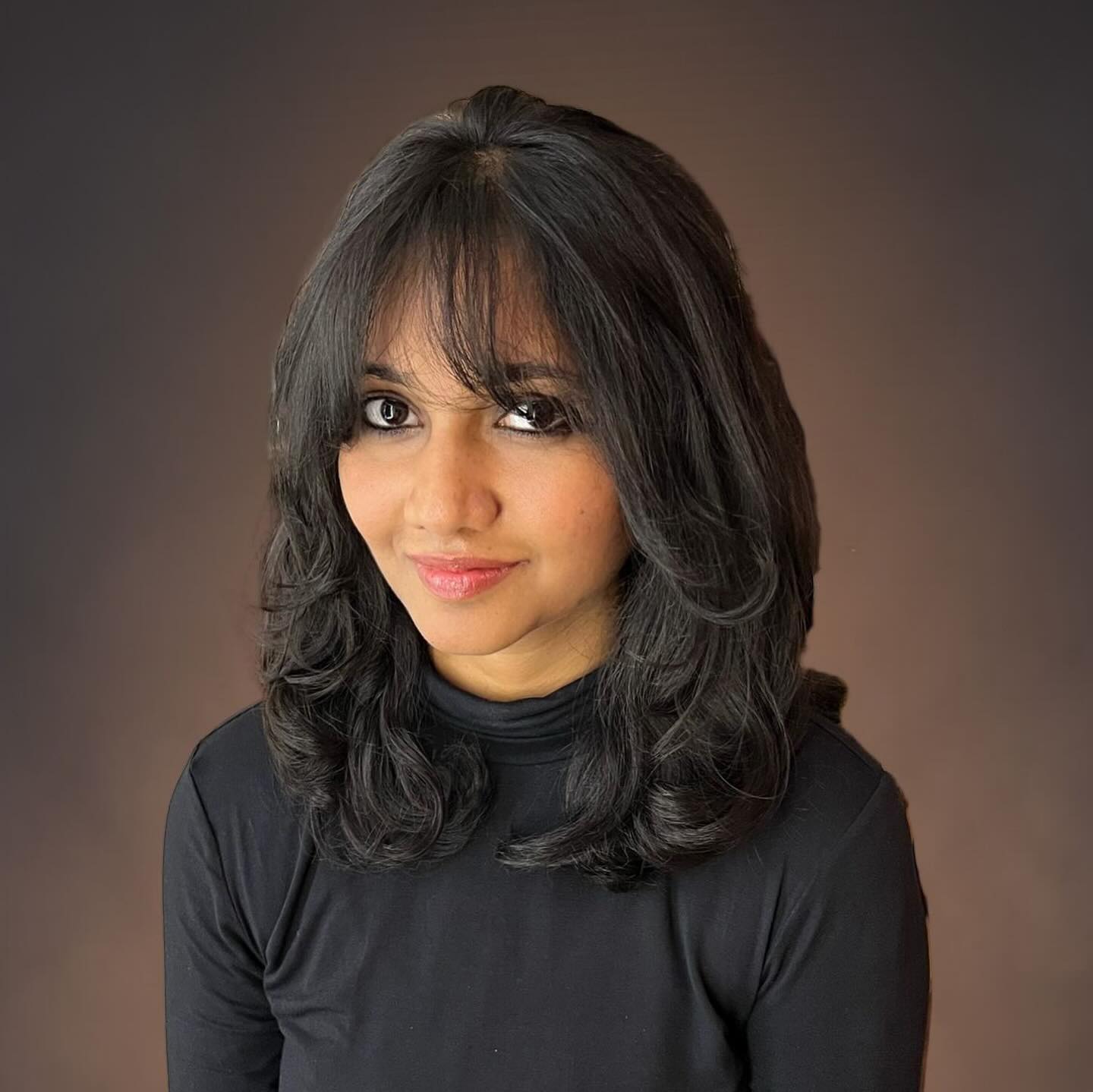 Voluminous Layered Shoulder-Length Cut with Wispy Brow-Grazing Fringe