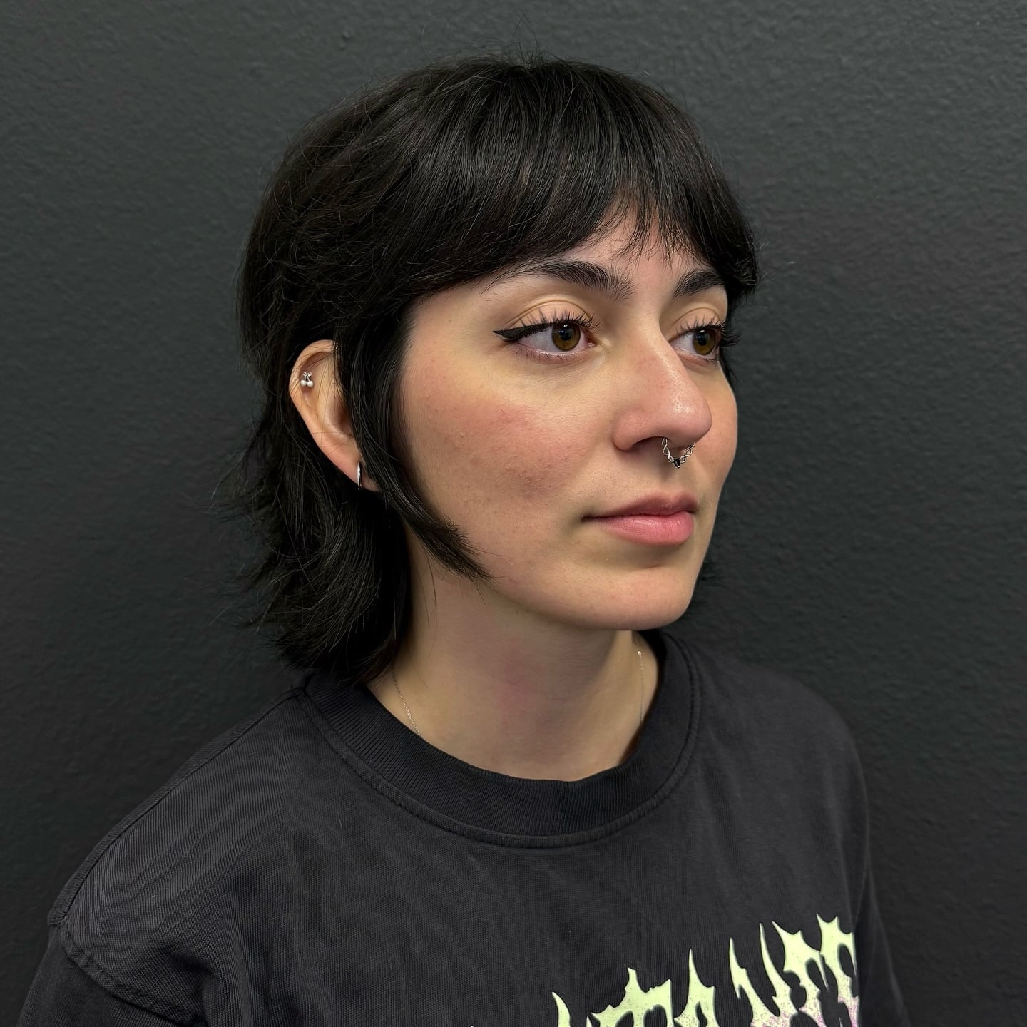 Short Black Wolf Cut with Feathered Nape and Micro Fringe