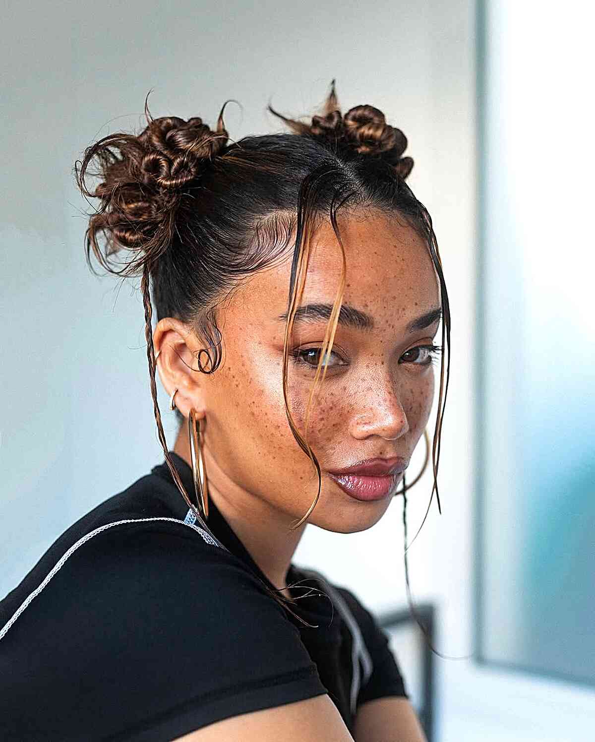Playful Double Buns with Face-Framing Tendrils