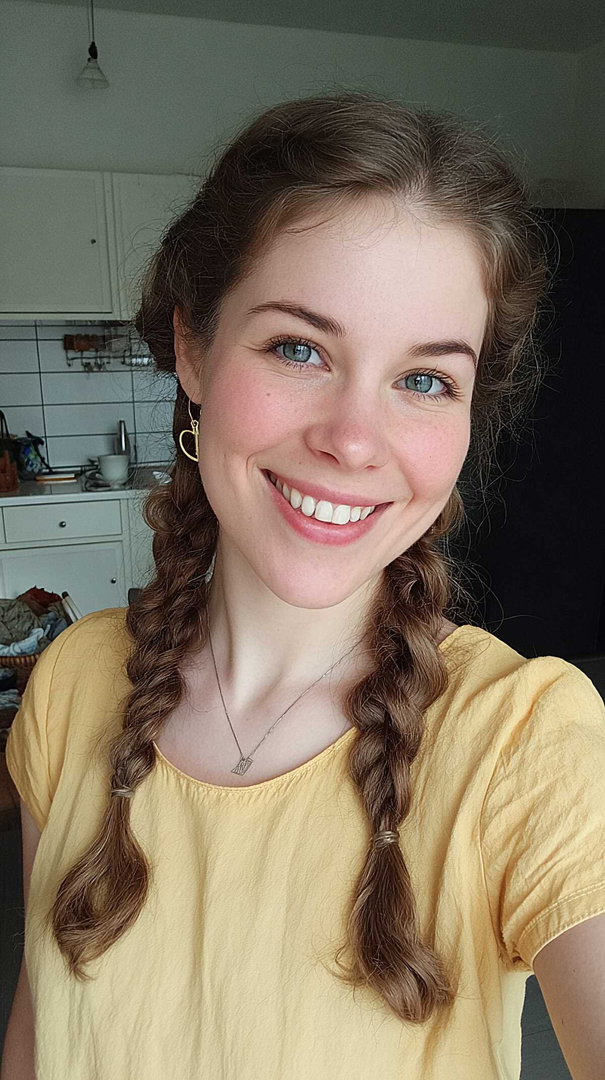 Two loose braids on light brown wavy hair