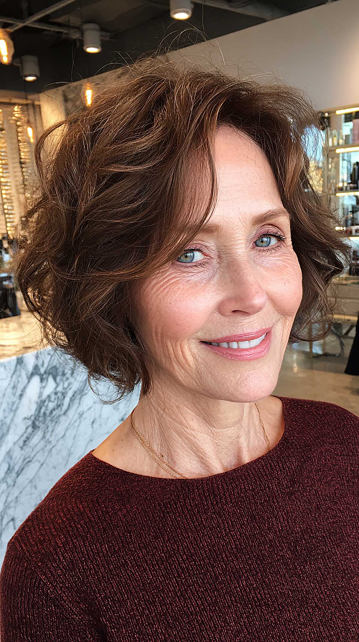 Warm brunette wavy full choppy bob hairstyle