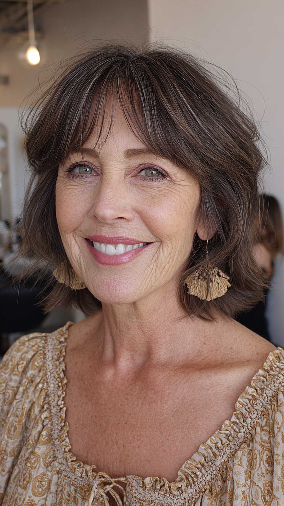 Layered brown bob with flipped ends and curtain bangs