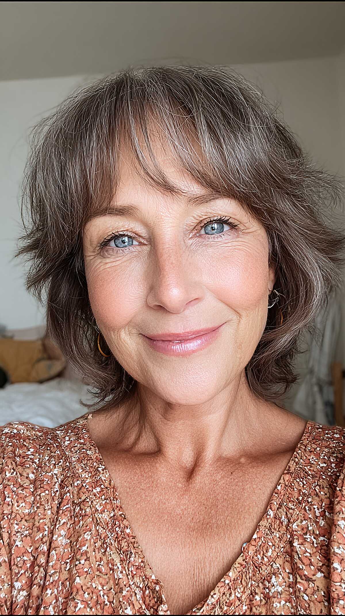 Gray and brown textured chin-length bob with curtain bangs