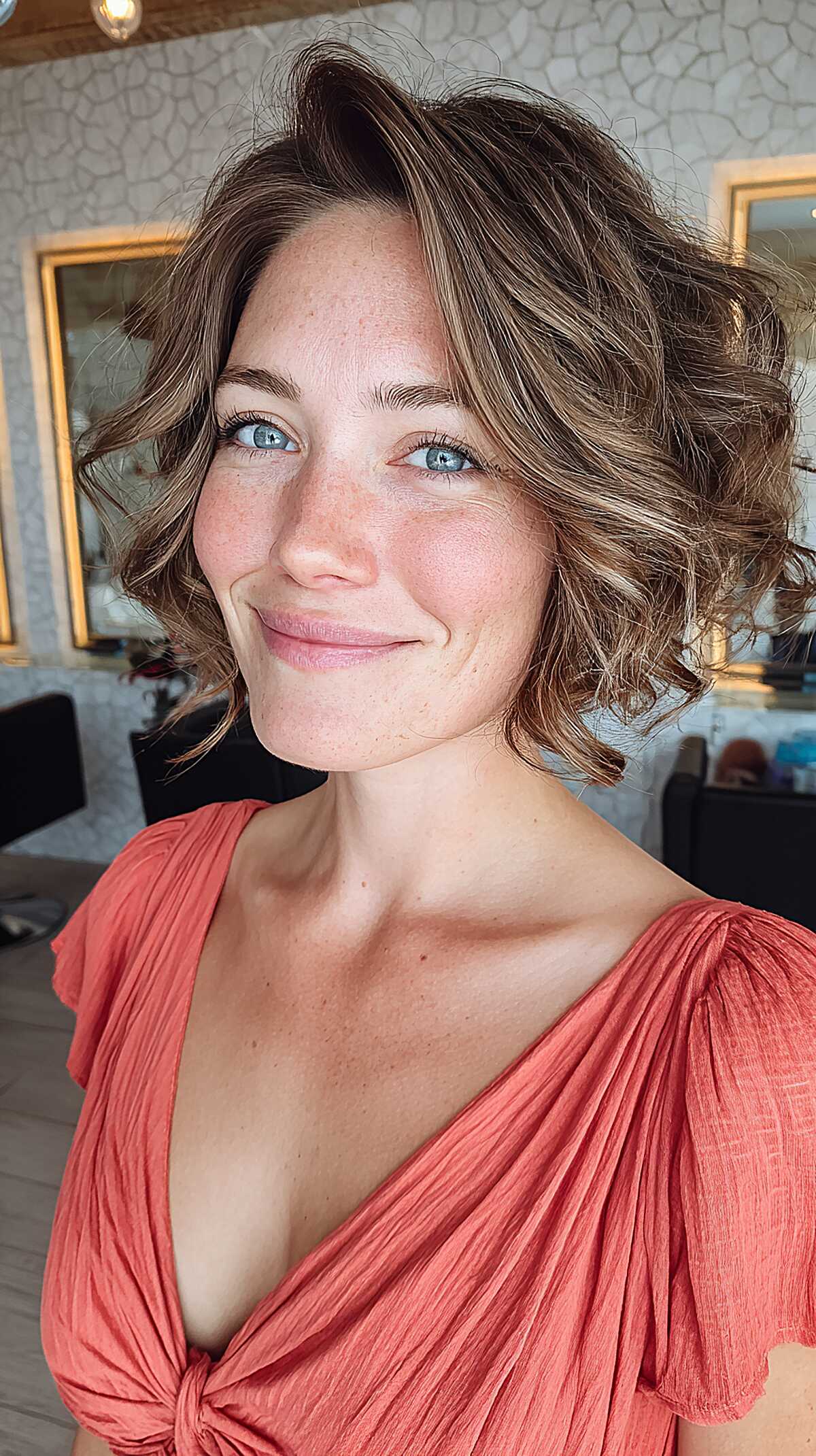 Short wavy bronde bob with side-swept bangs and highlights