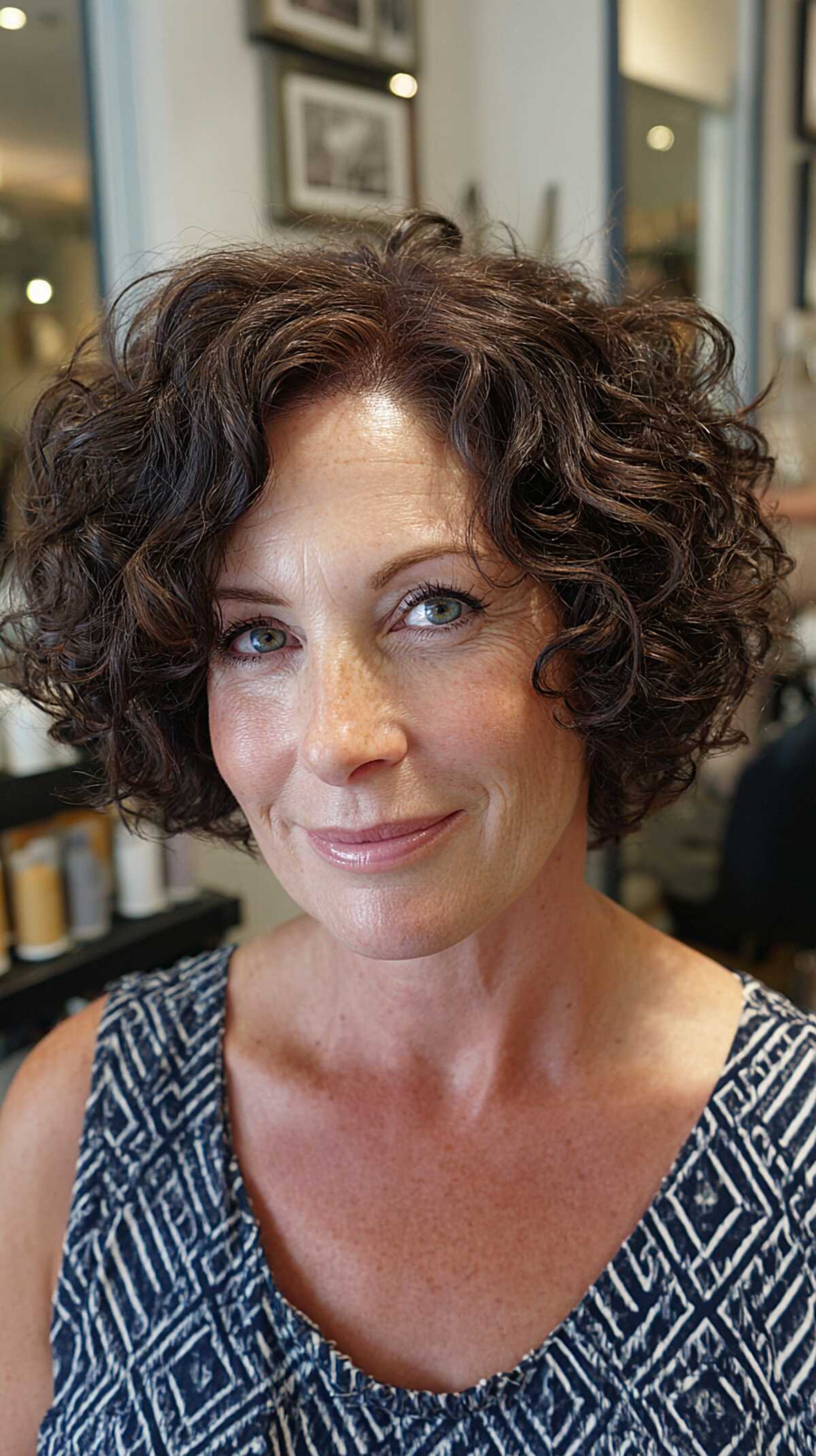 Dark brunette curly bob with rounded shape and crown volume
