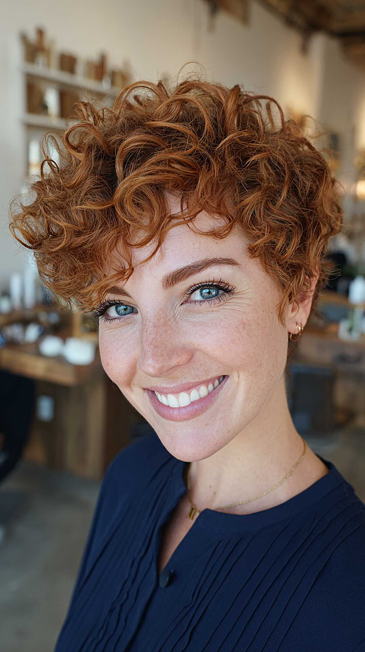 Short copper curly pixie with tight spirals on top