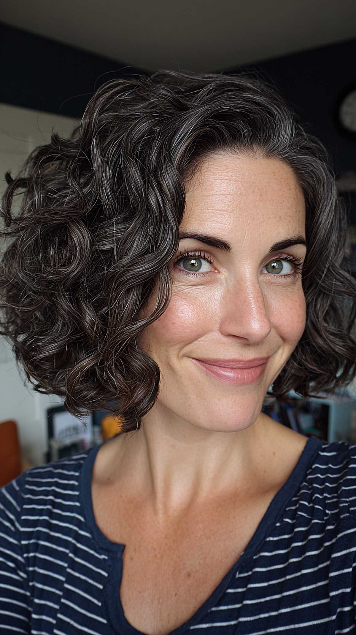 Dark brown curly bob with defined swirling curl pattern