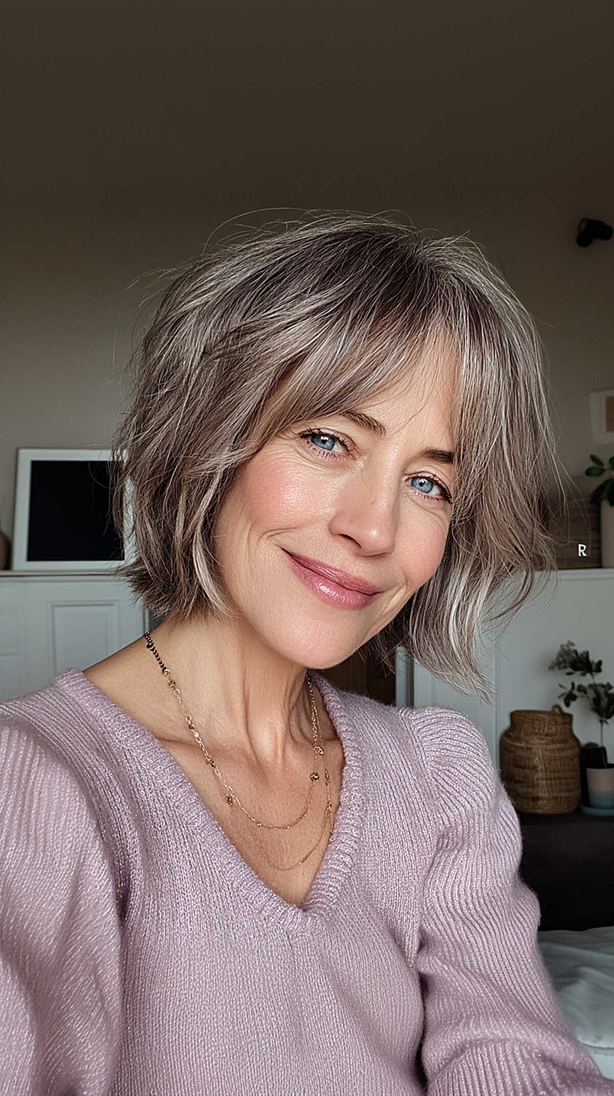 Silver-toned layered shag bob with wispy curtain bangs