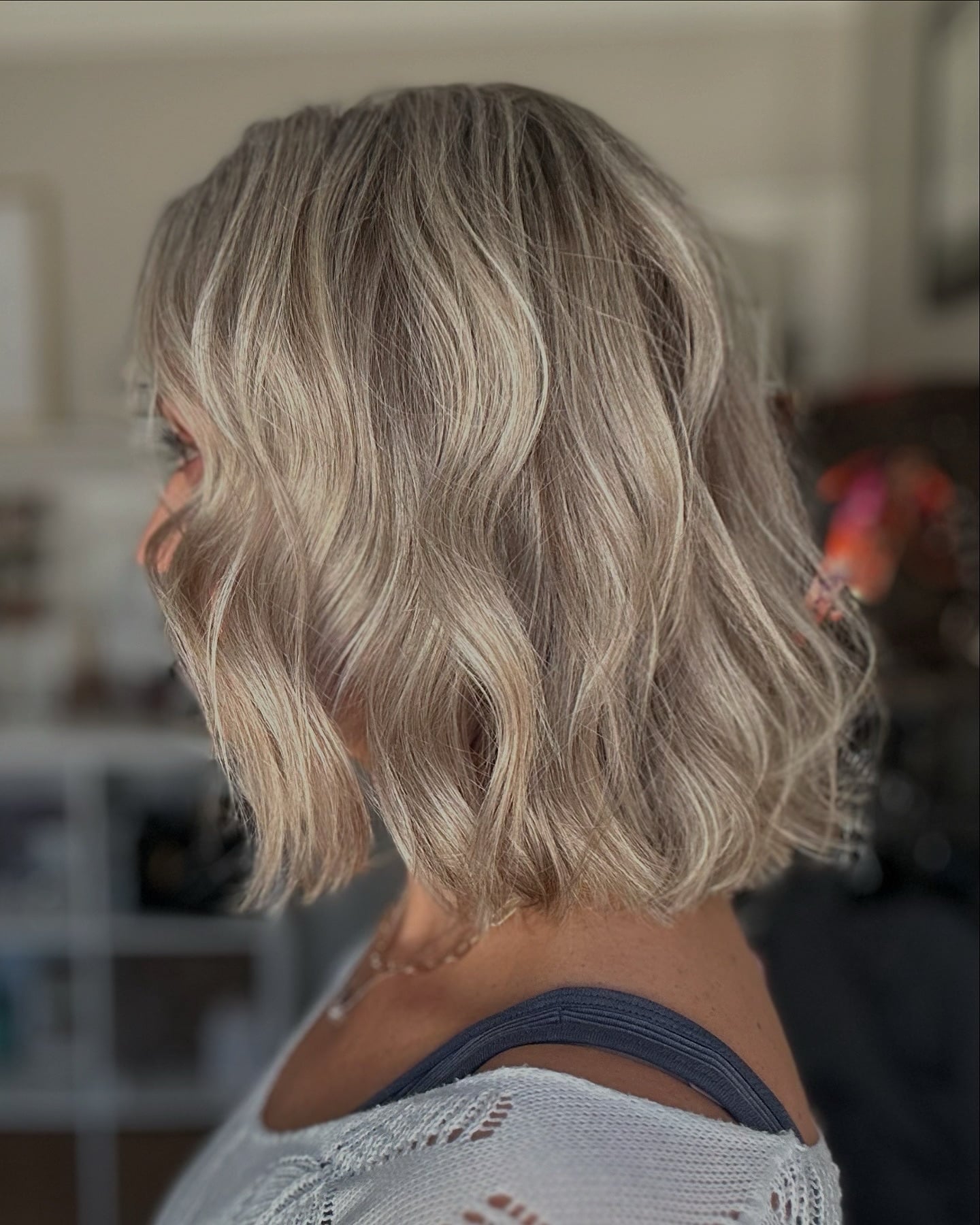 Wavy ash blonde bob at shoulder length, back view