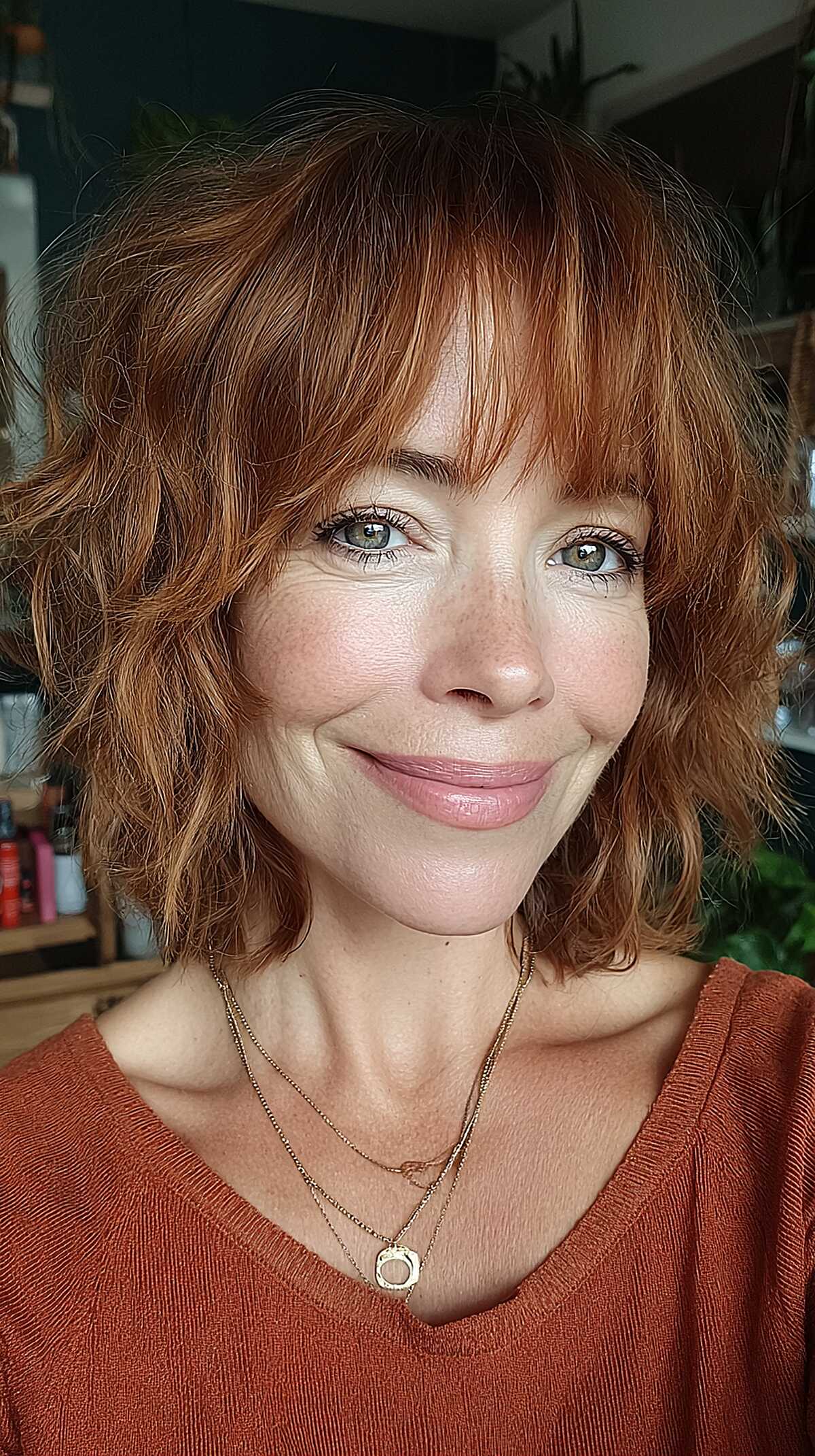 Auburn copper wavy shag bob with curtain bangs