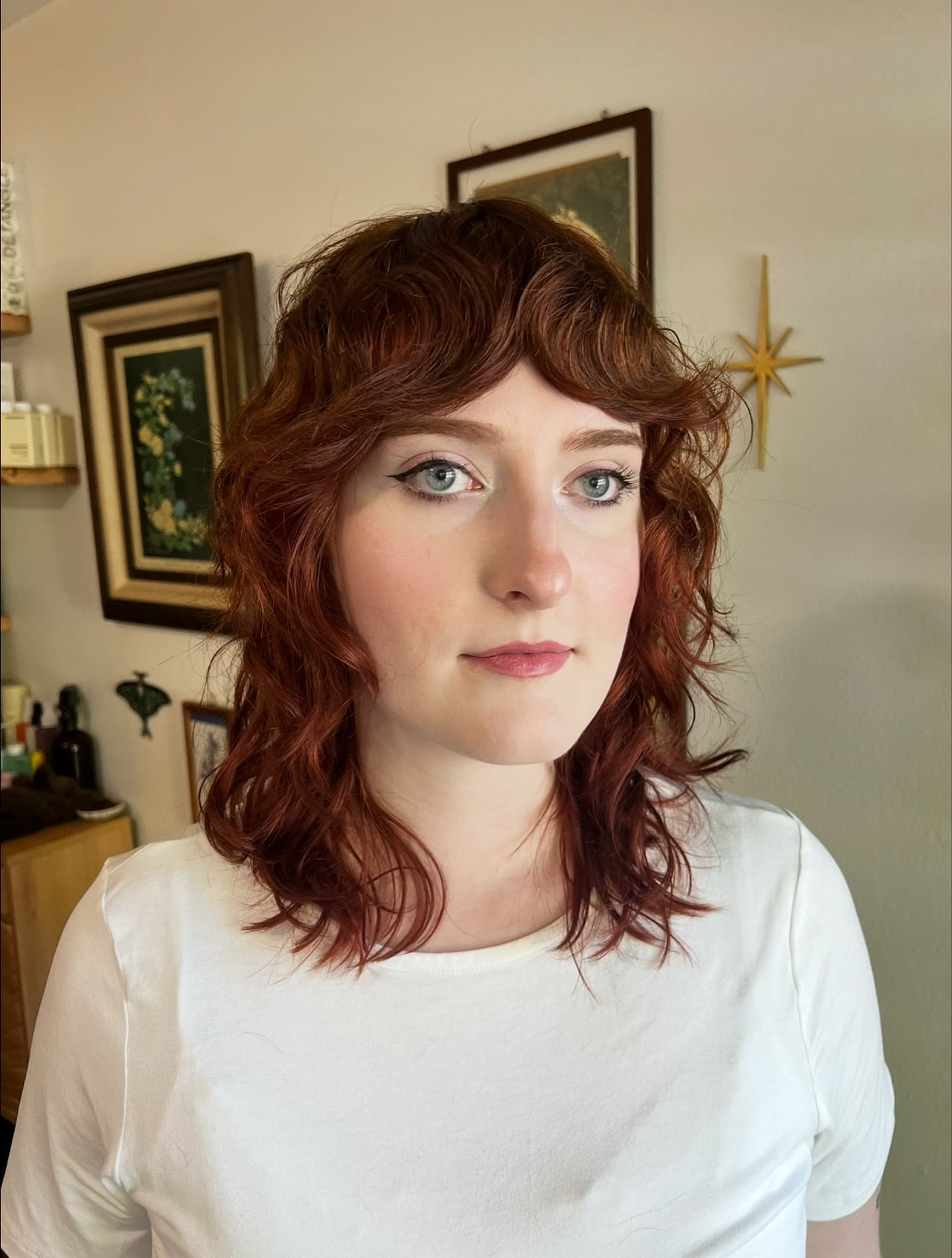 Wavy auburn shoulder-length cut with curtain fringe