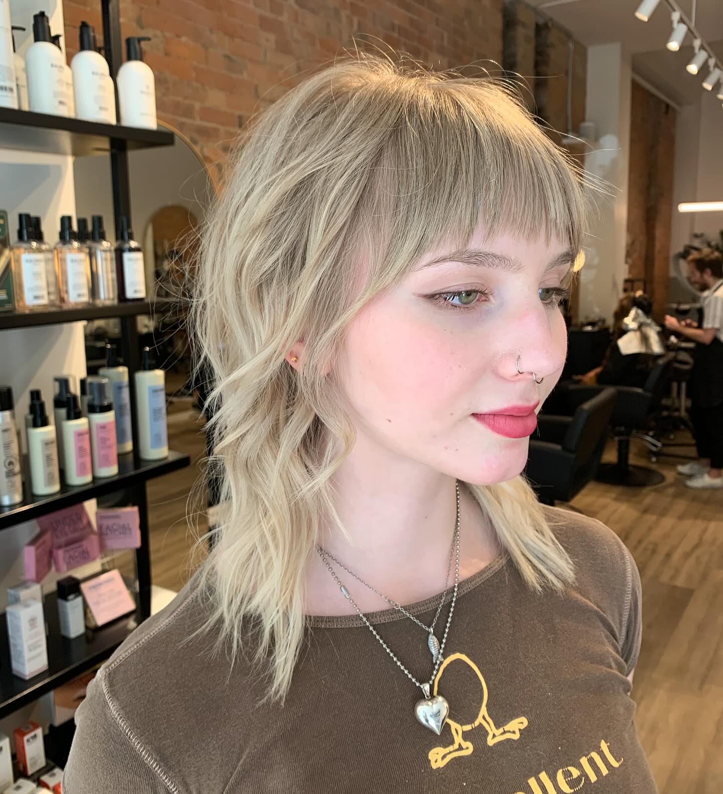 Ash blonde shaggy lob with full fringe and waves
