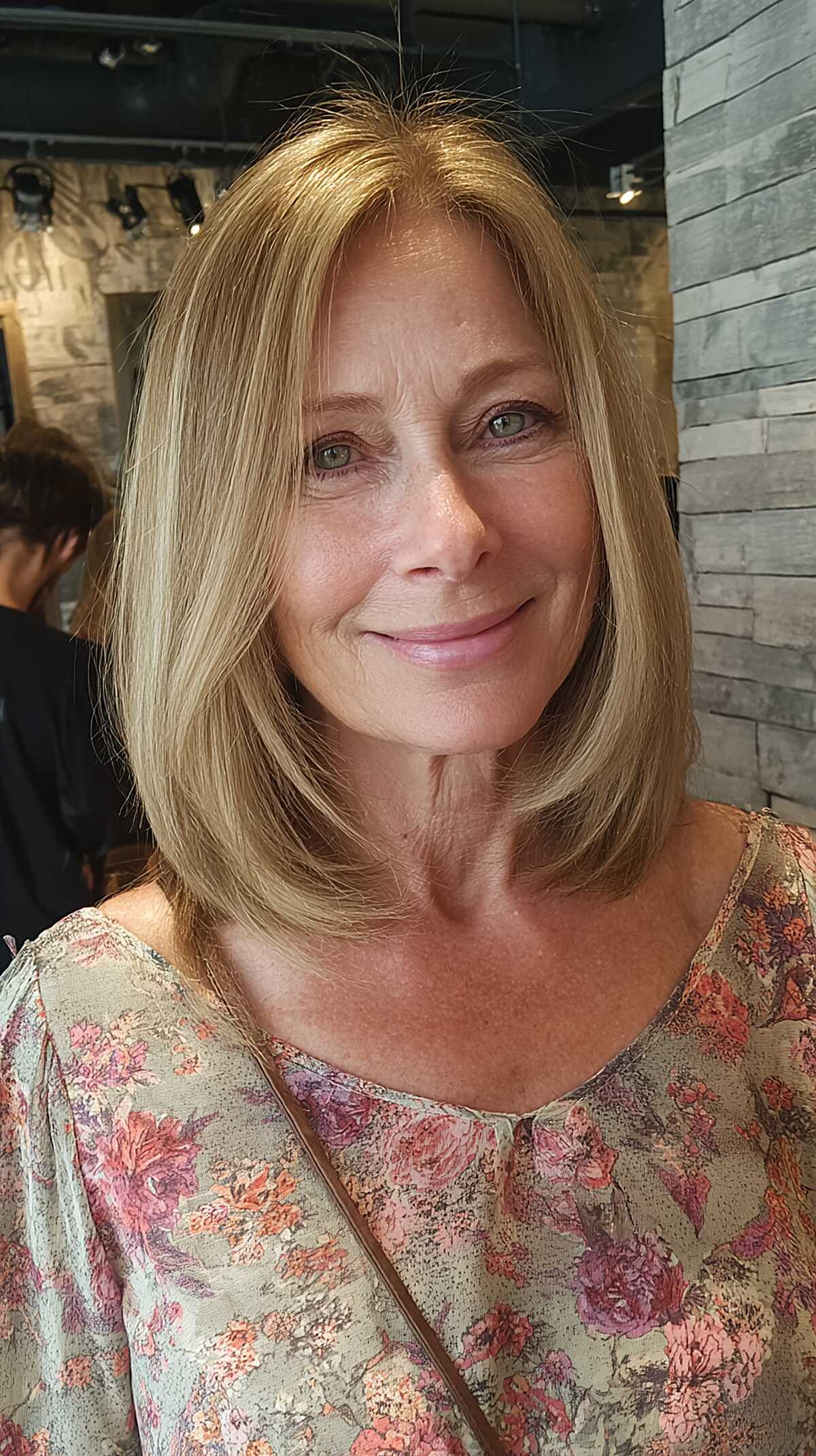 Butter blonde layered lob with side part in salon