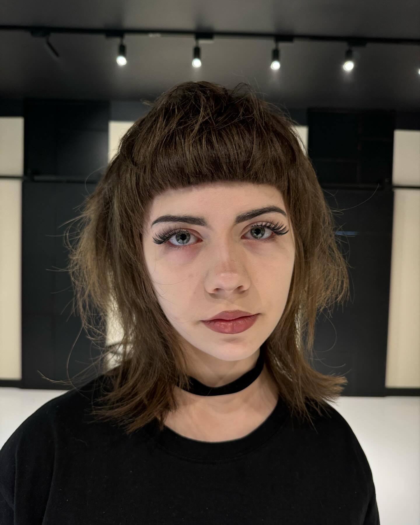 Choppy brown bob with blunt micro bangs