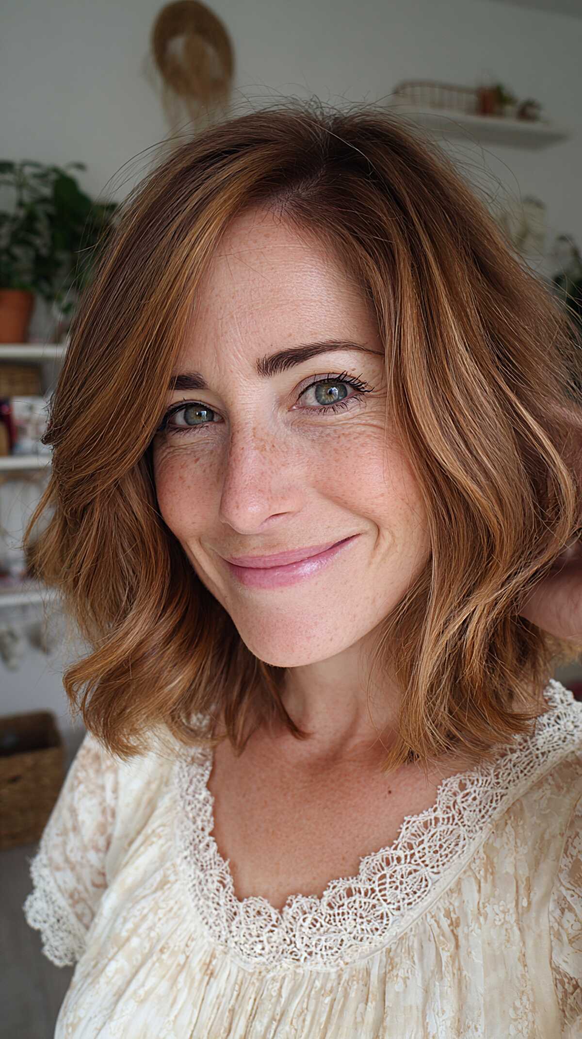Copper auburn wavy lob with soft side part and highlights