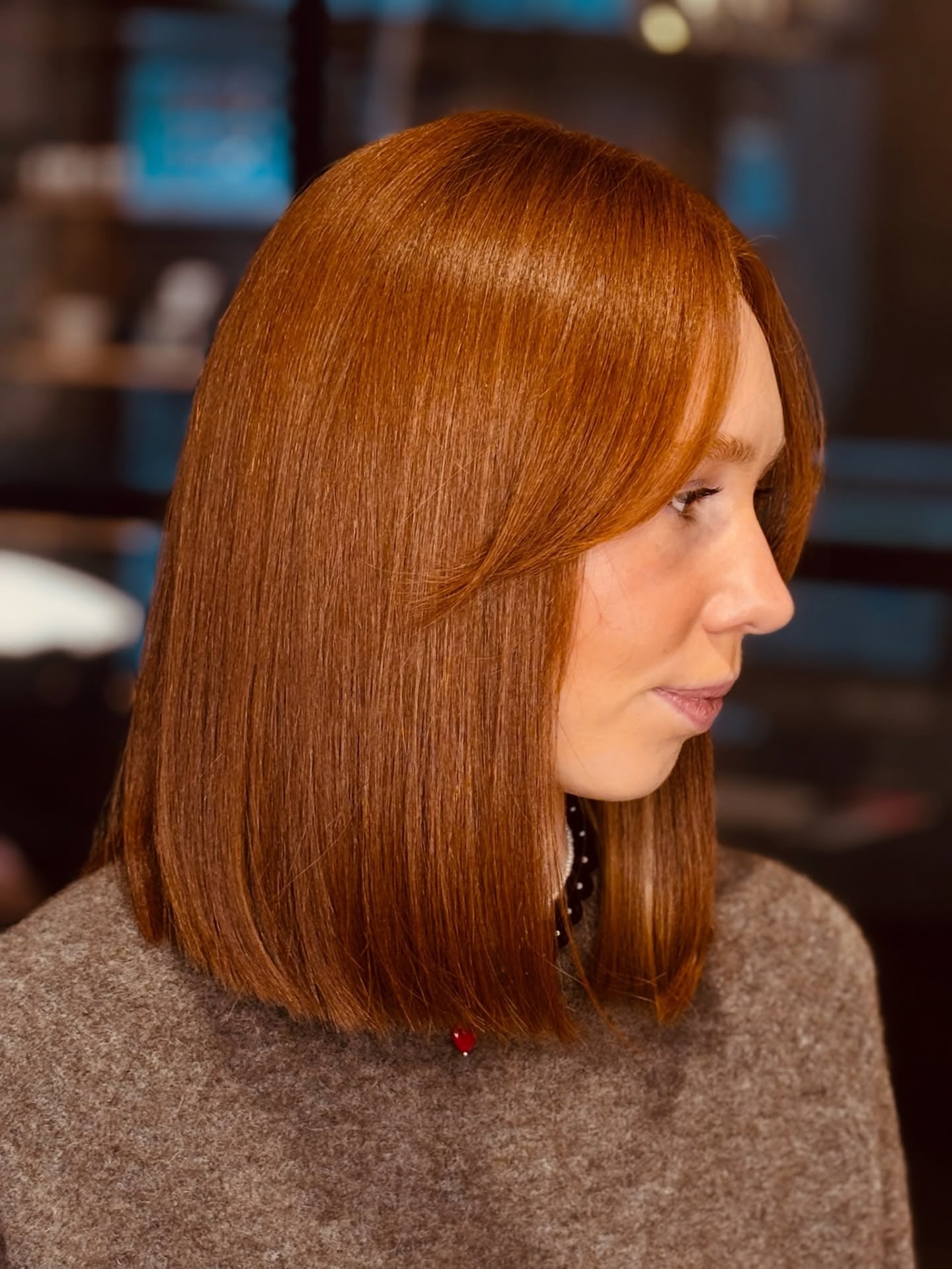 Sleek copper red blunt bob at shoulder length