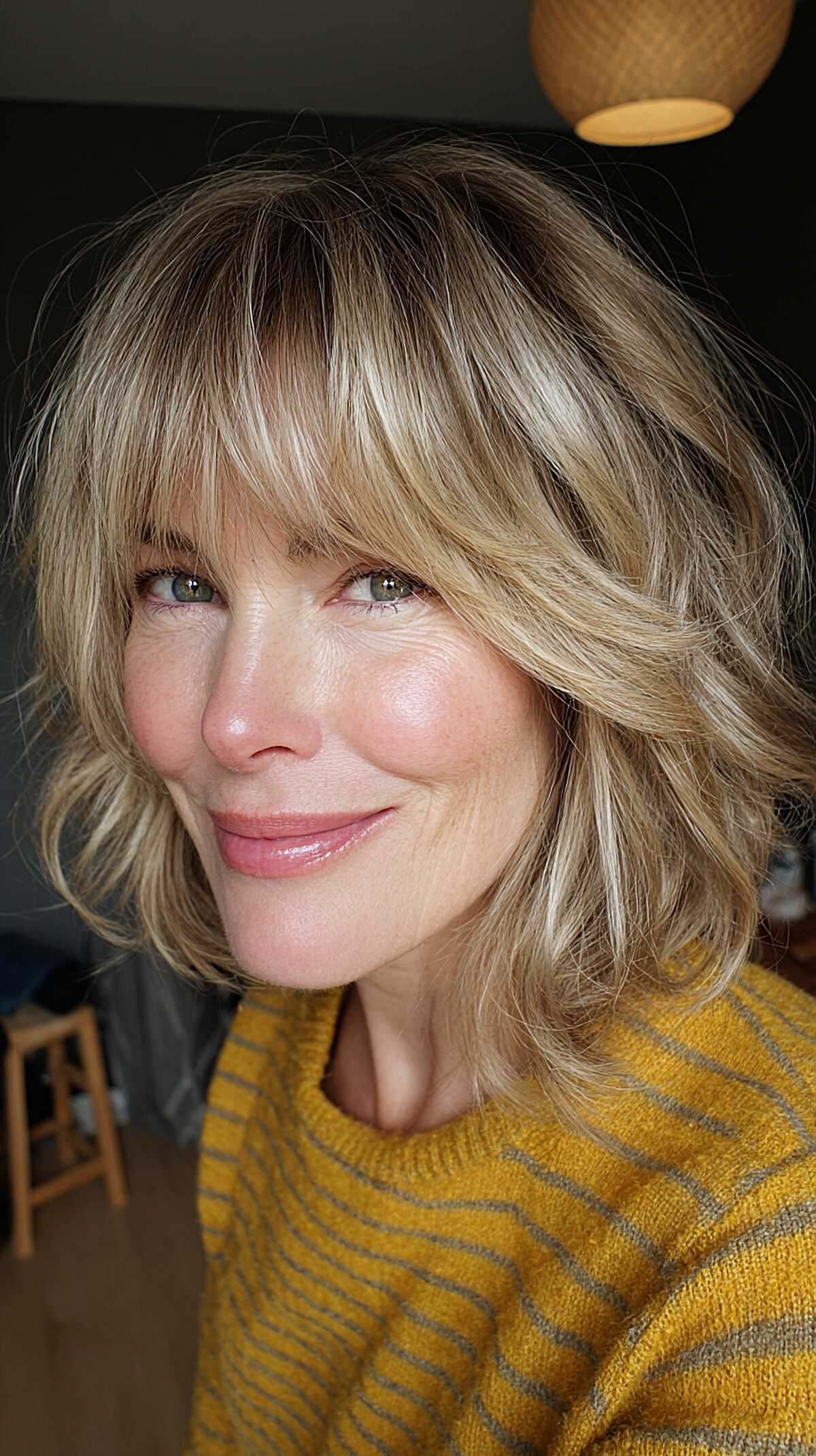Dimensional blonde layered shag bob with full bangs