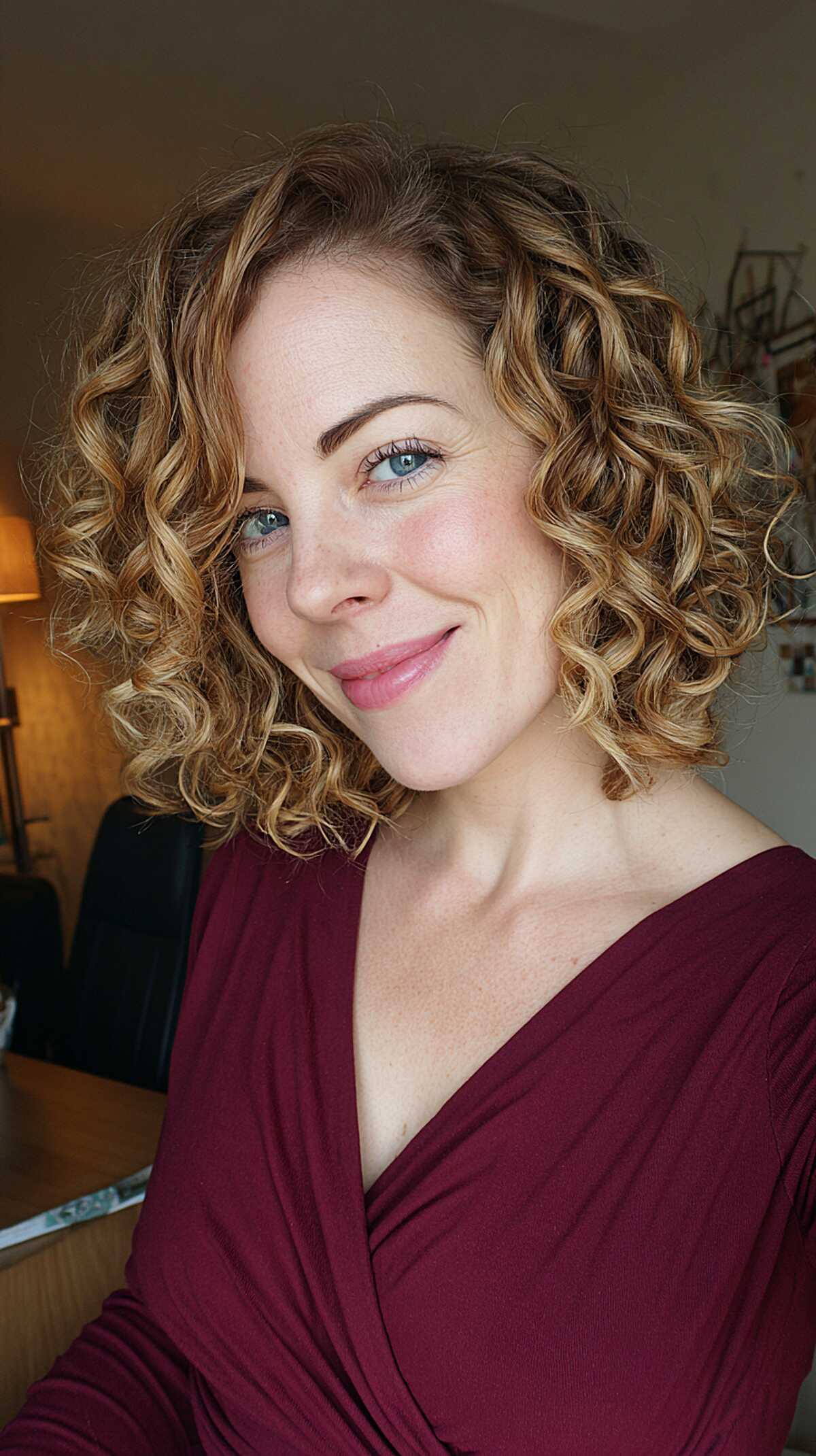 Defined golden ringlet curls in a side-parted bob