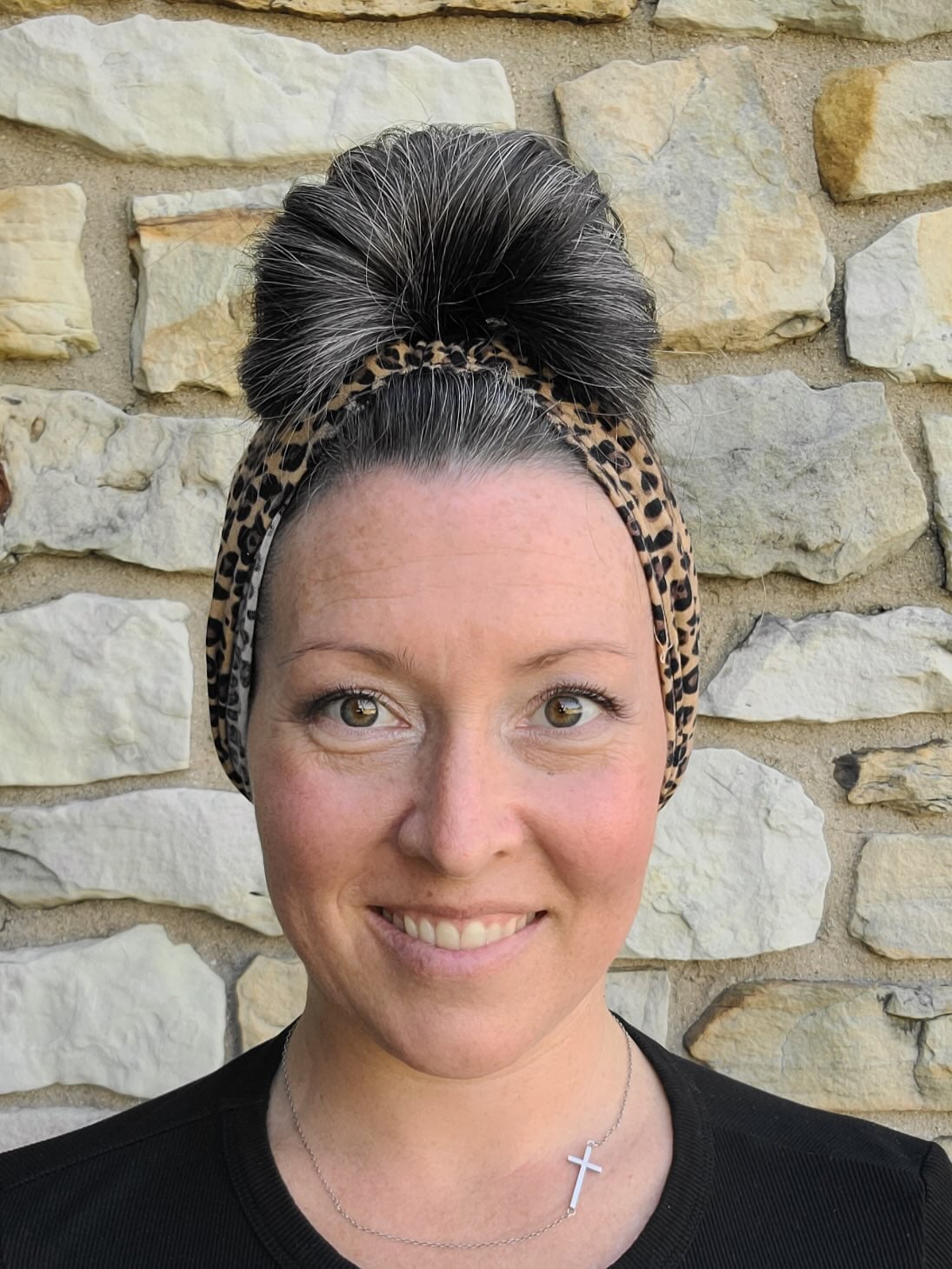 High messy bun with salt and pepper hair and leopard band