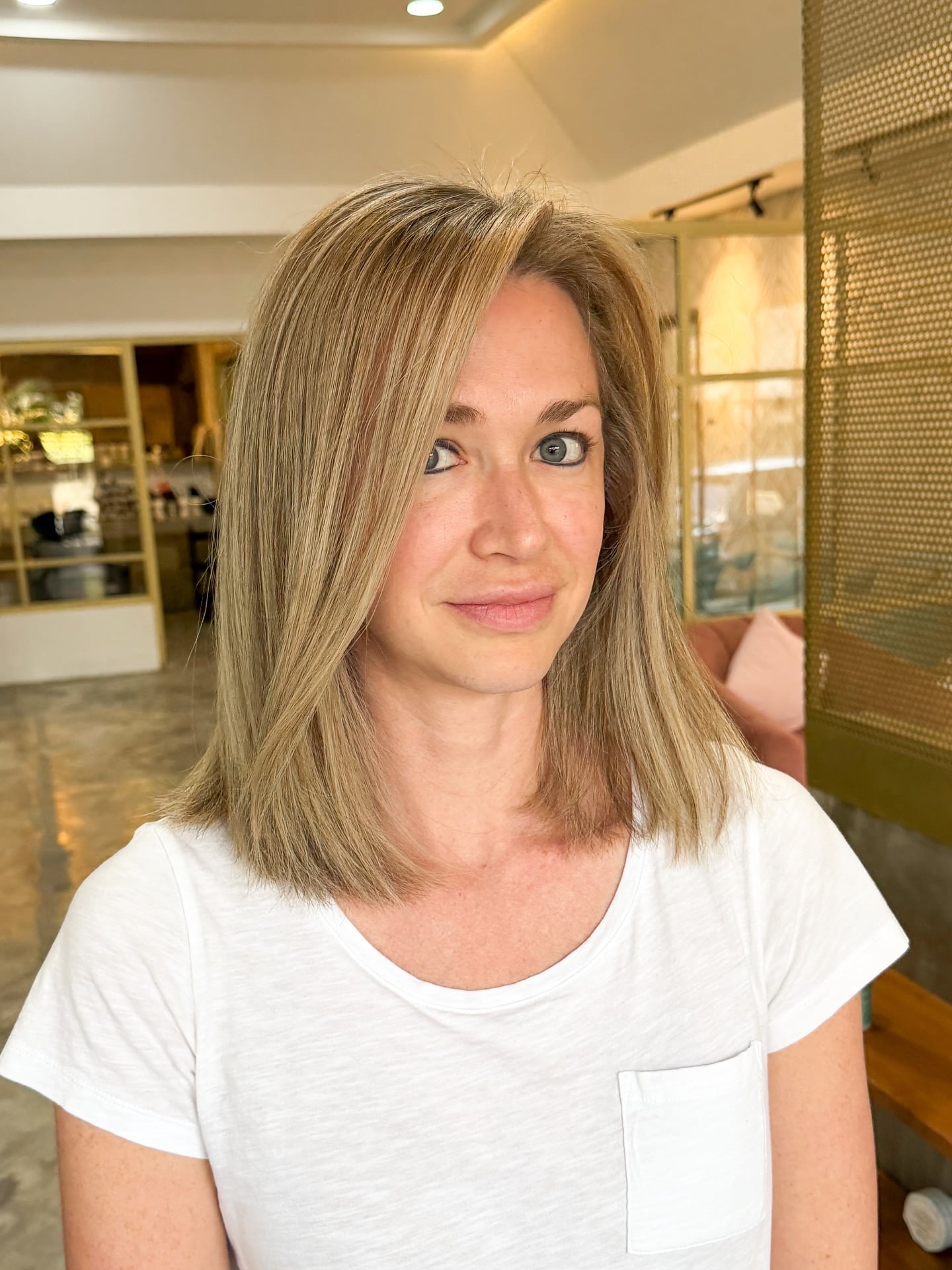 Side-swept honey blonde lob with fine highlights