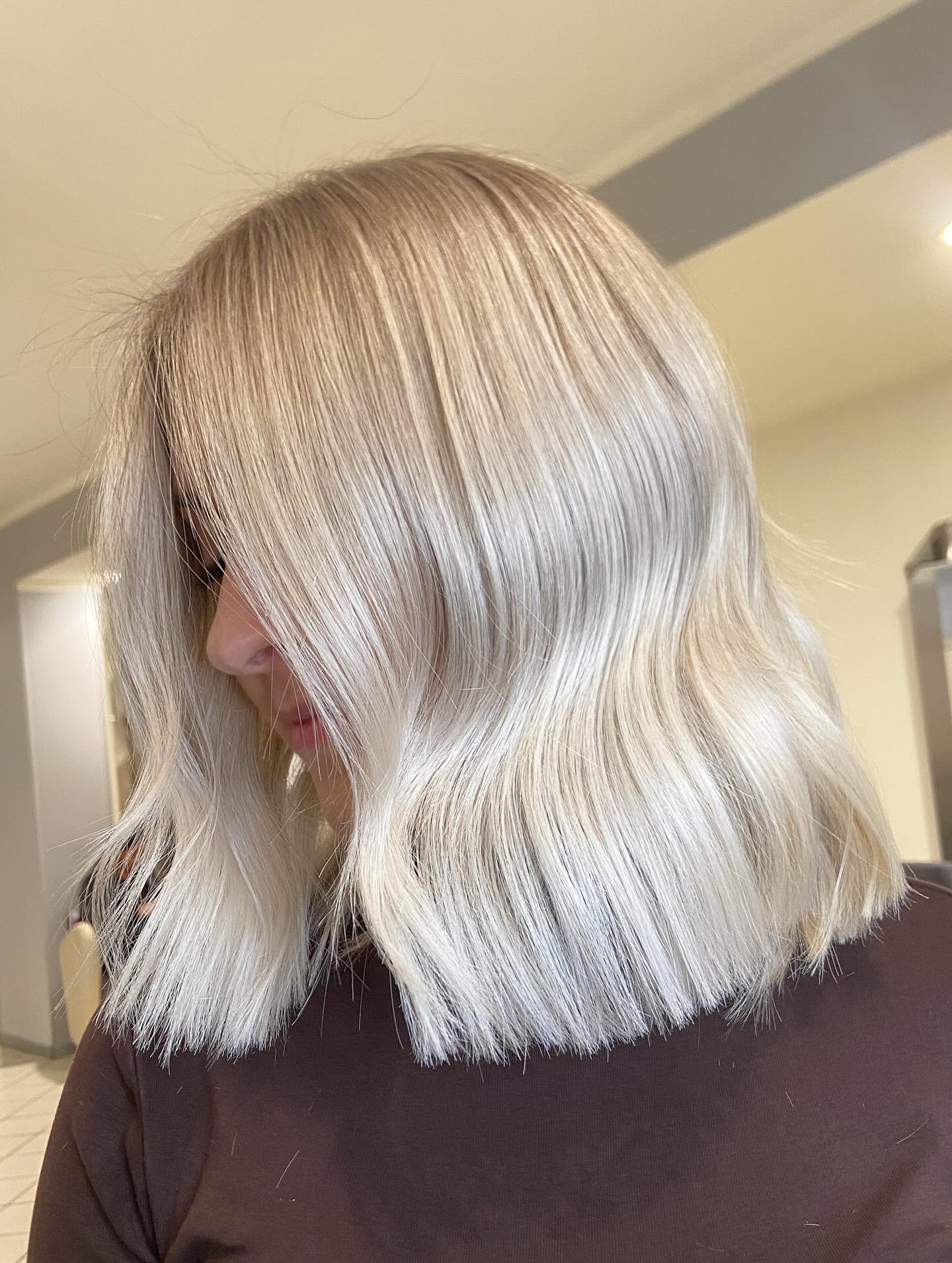 Platinum blonde shoulder-length lob with flipped ends