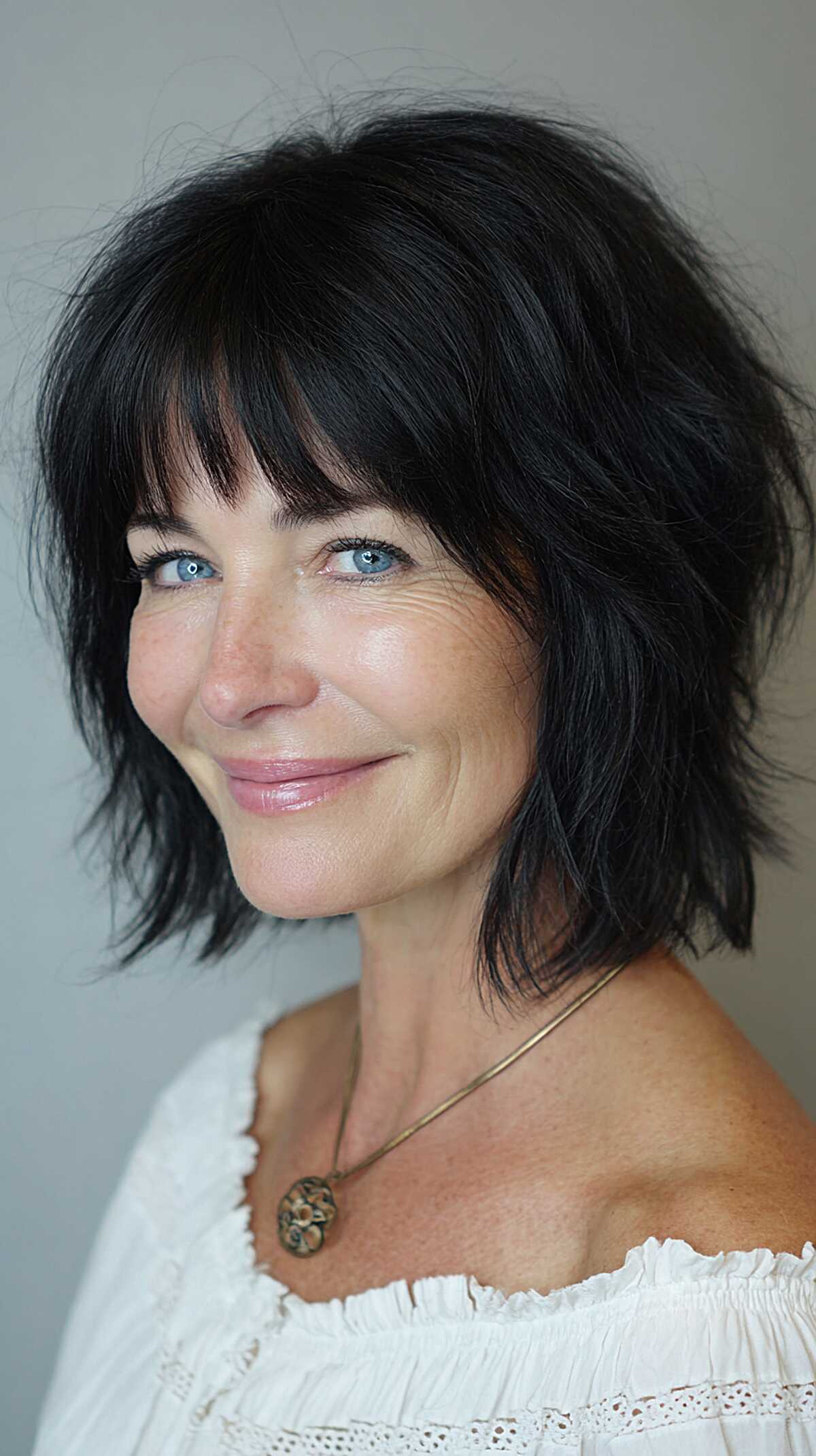 Jet black chin-length shaggy bob with soft fringe