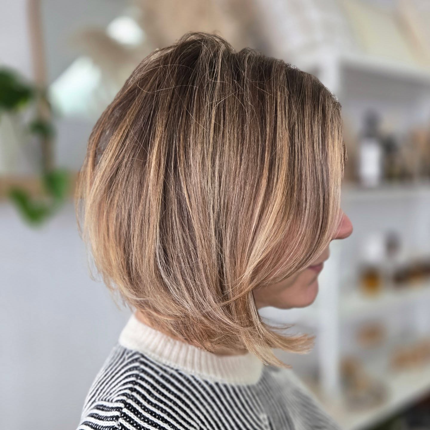 Layered chin-length bob with warm honey balayage