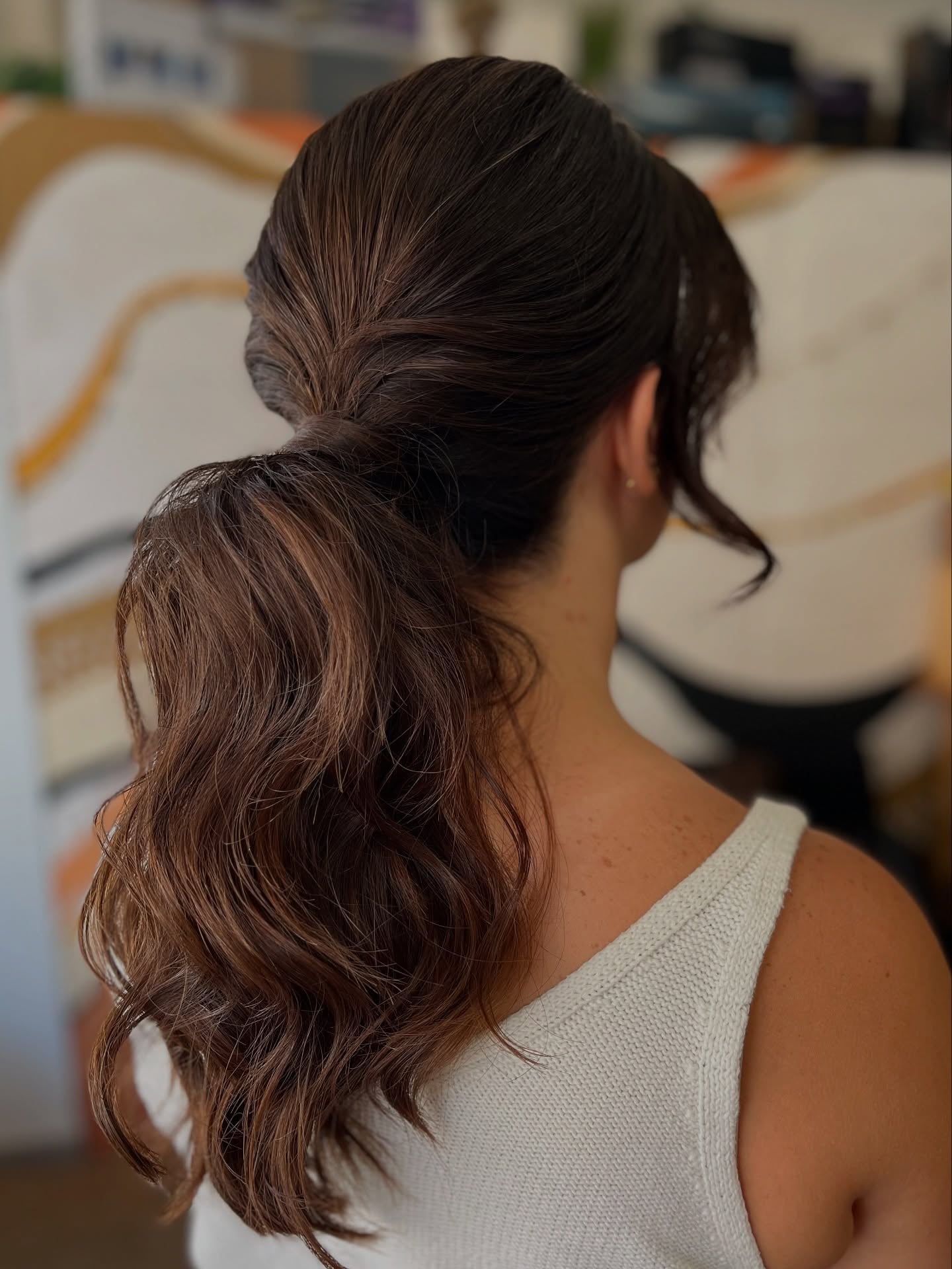 Wavy brunette low ponytail with volume at the crown