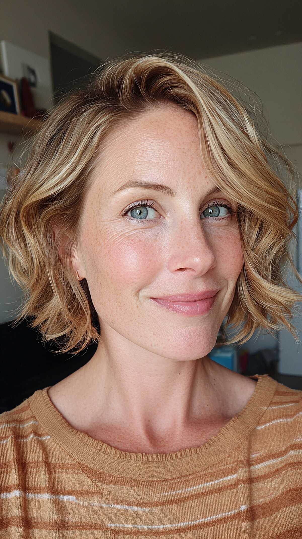 Chin-length wavy honey blonde bob with relaxed side part
