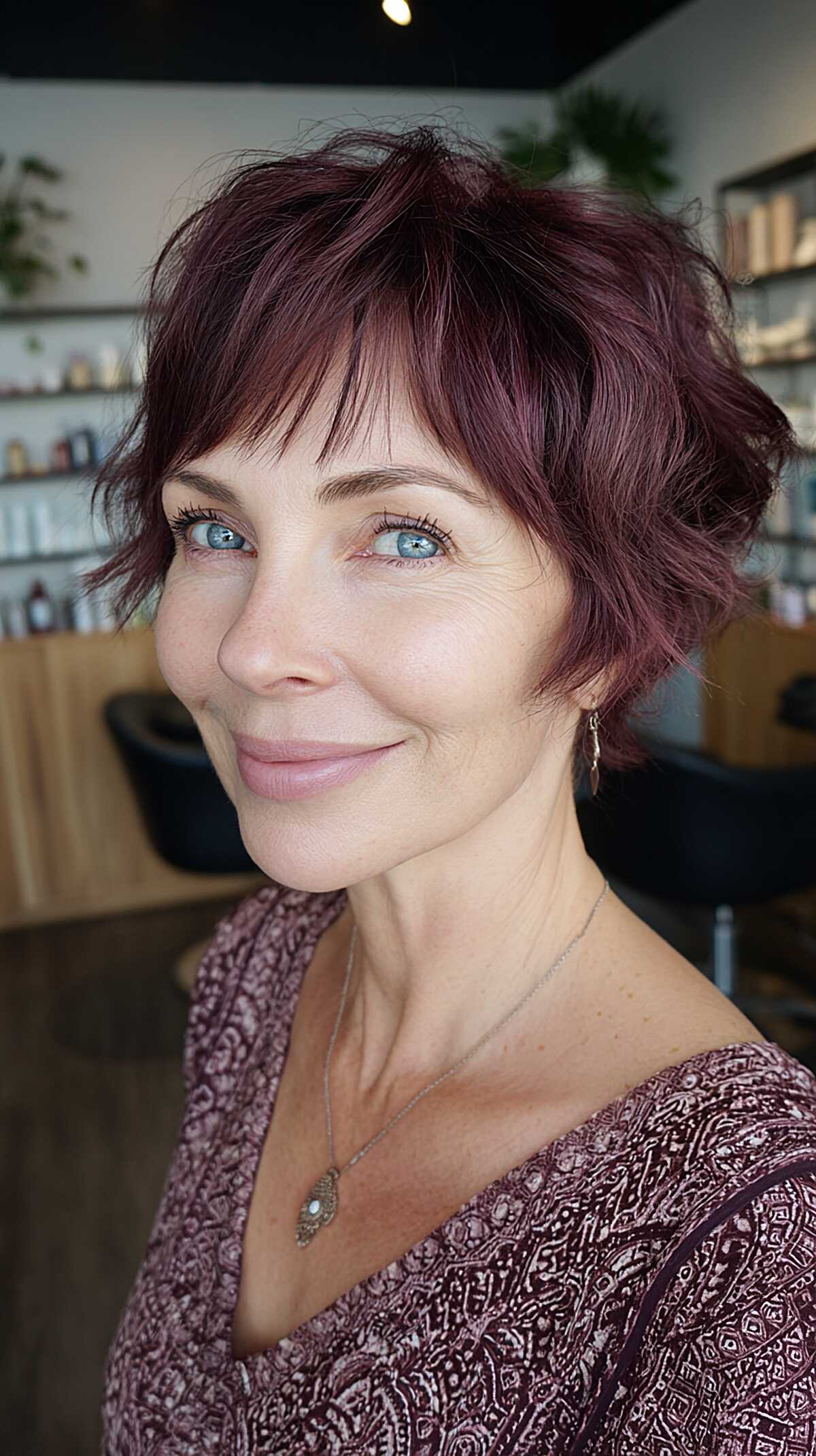 Short plum-colored shaggy pixie with textured bangs