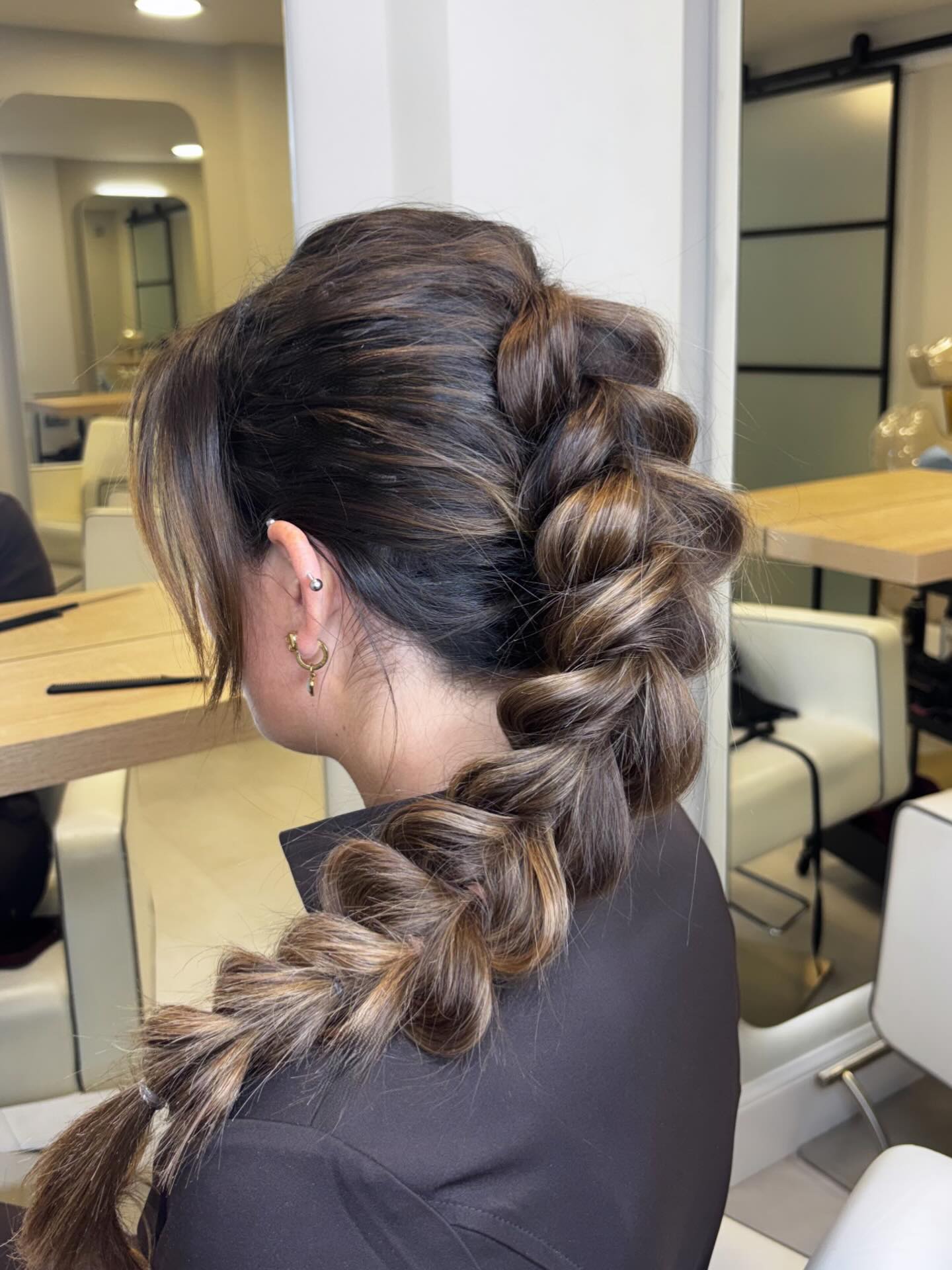 Brunette Dutch braid pulled apart for a thick, full look