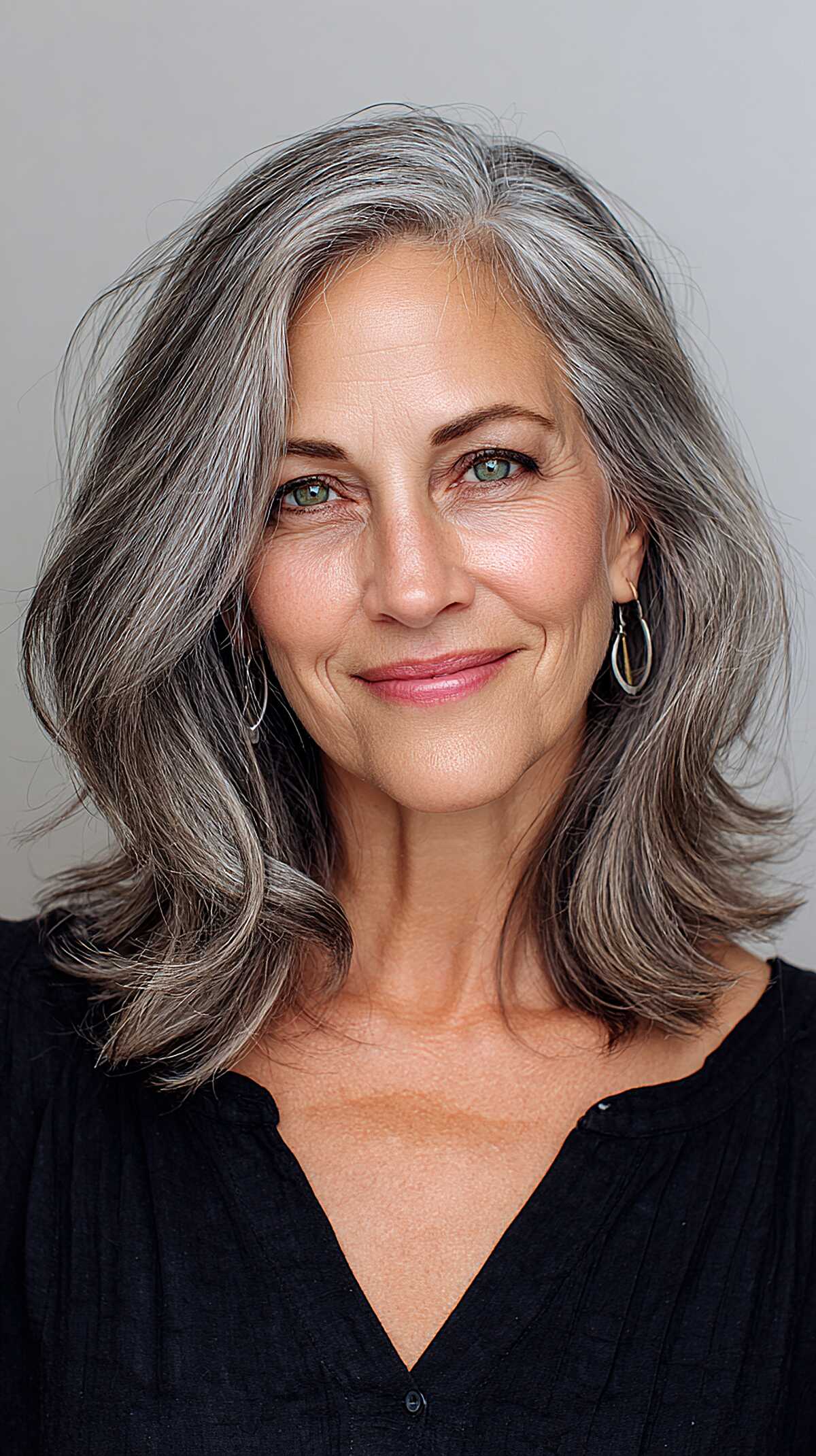 Wavy salt and pepper shoulder length hair with side part
