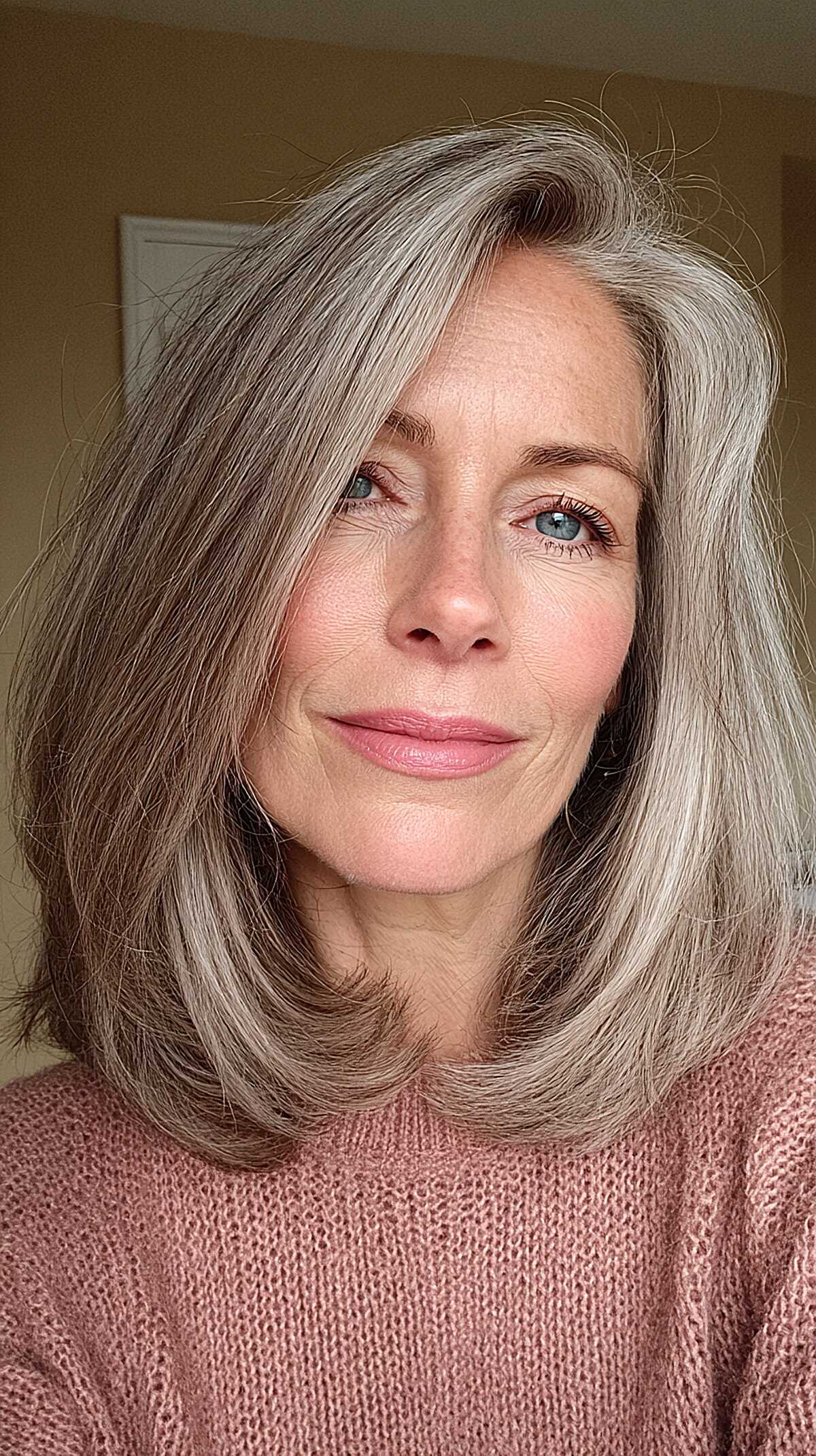 Silver smoke shoulder length blowout with deep side part
