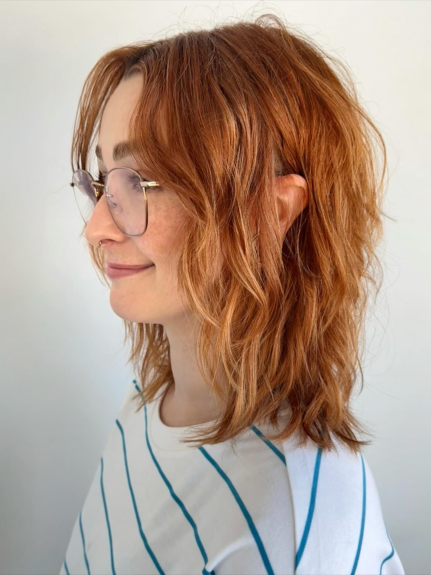 Copper red textured shoulder-length shag, side view