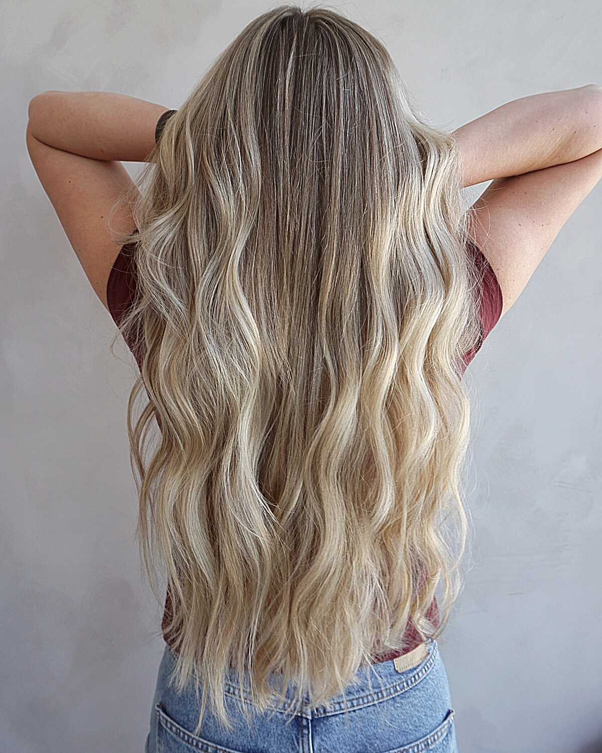 Long beachy blonde balayage with dark brunette roots