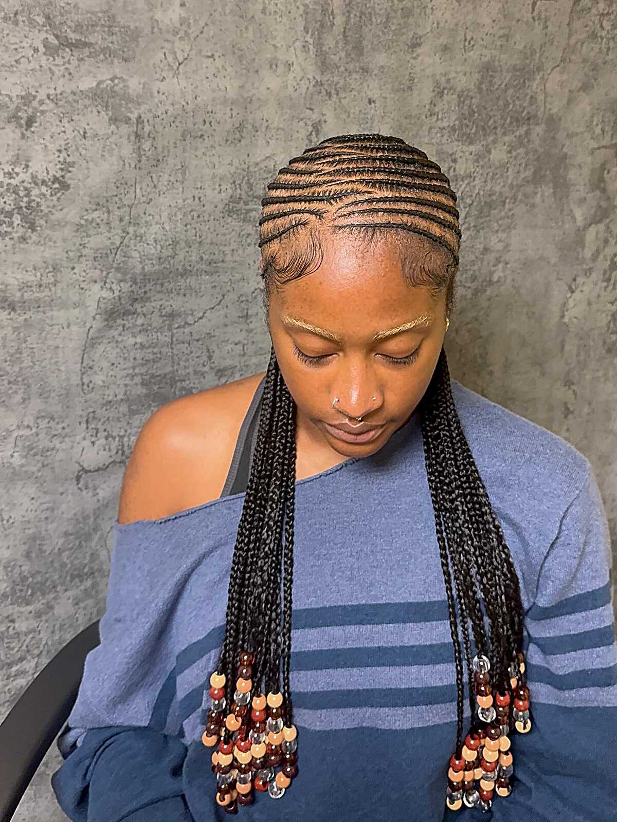 Straight-back cornrows with wooden beads at the ends