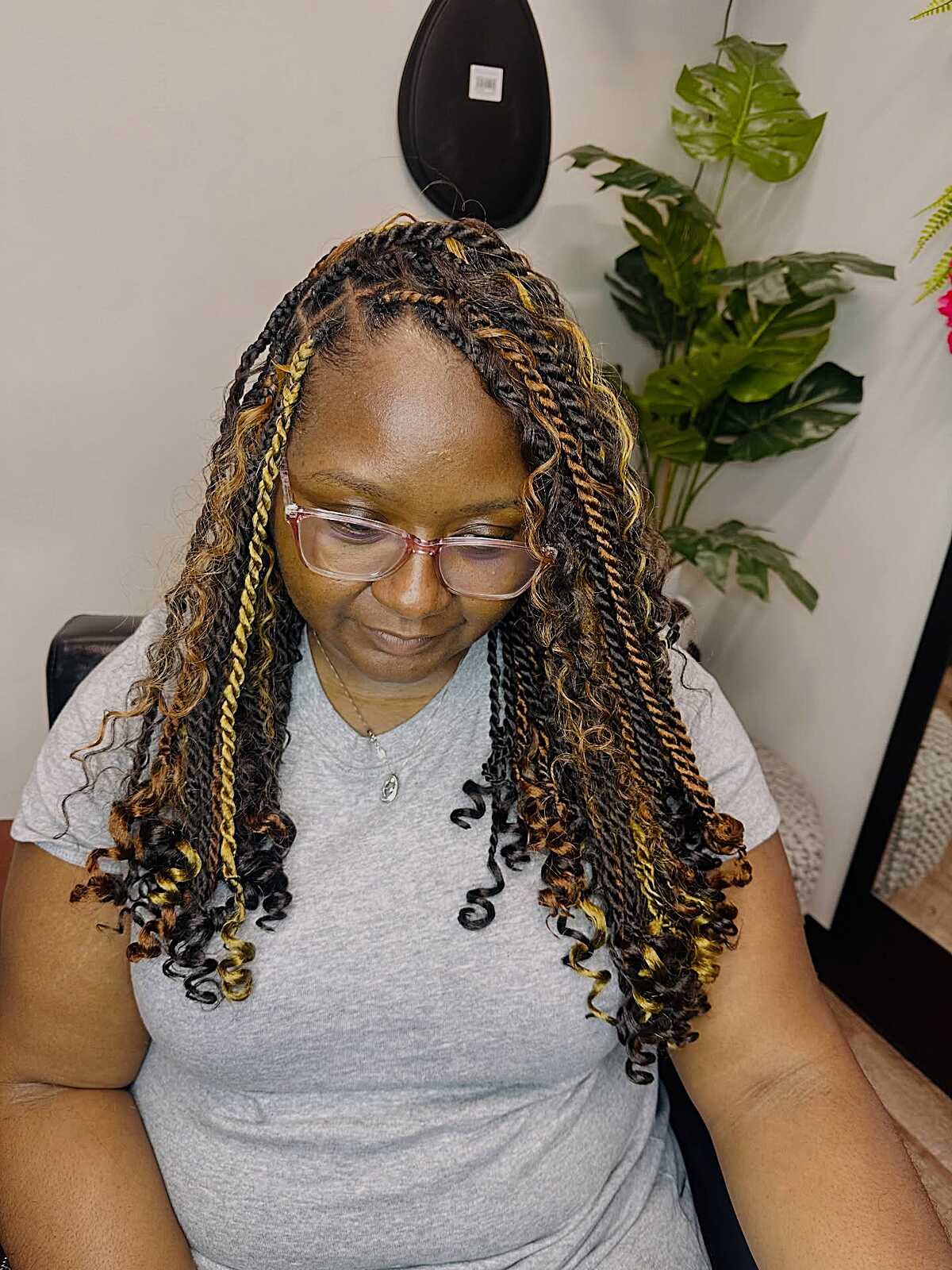 Black twists with golden blonde streaks and curly ends