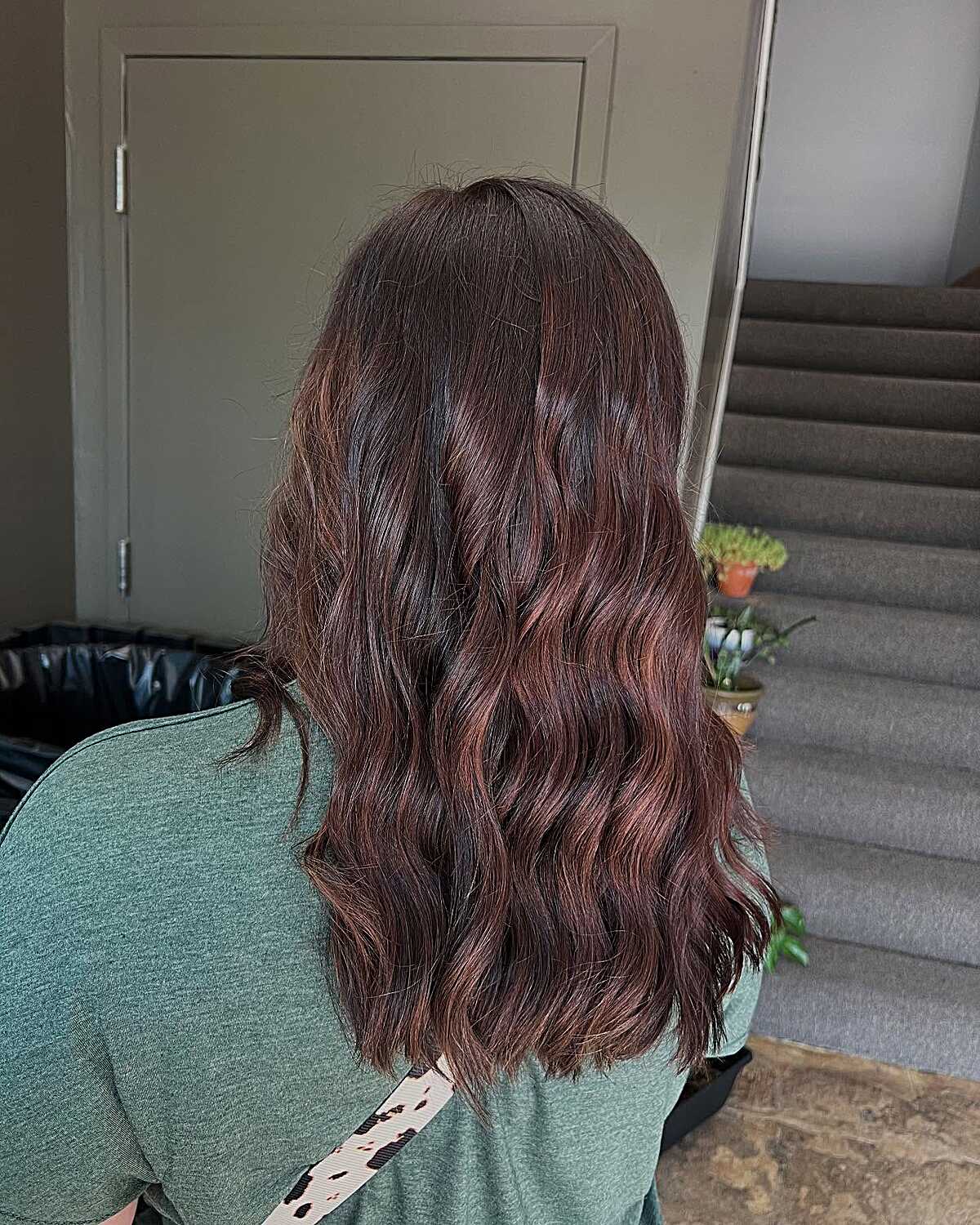 Dark brunette waves with black cherry red undertones