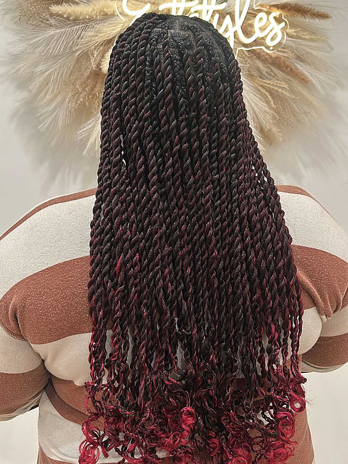 Long black twists fading to burgundy-red curled tips