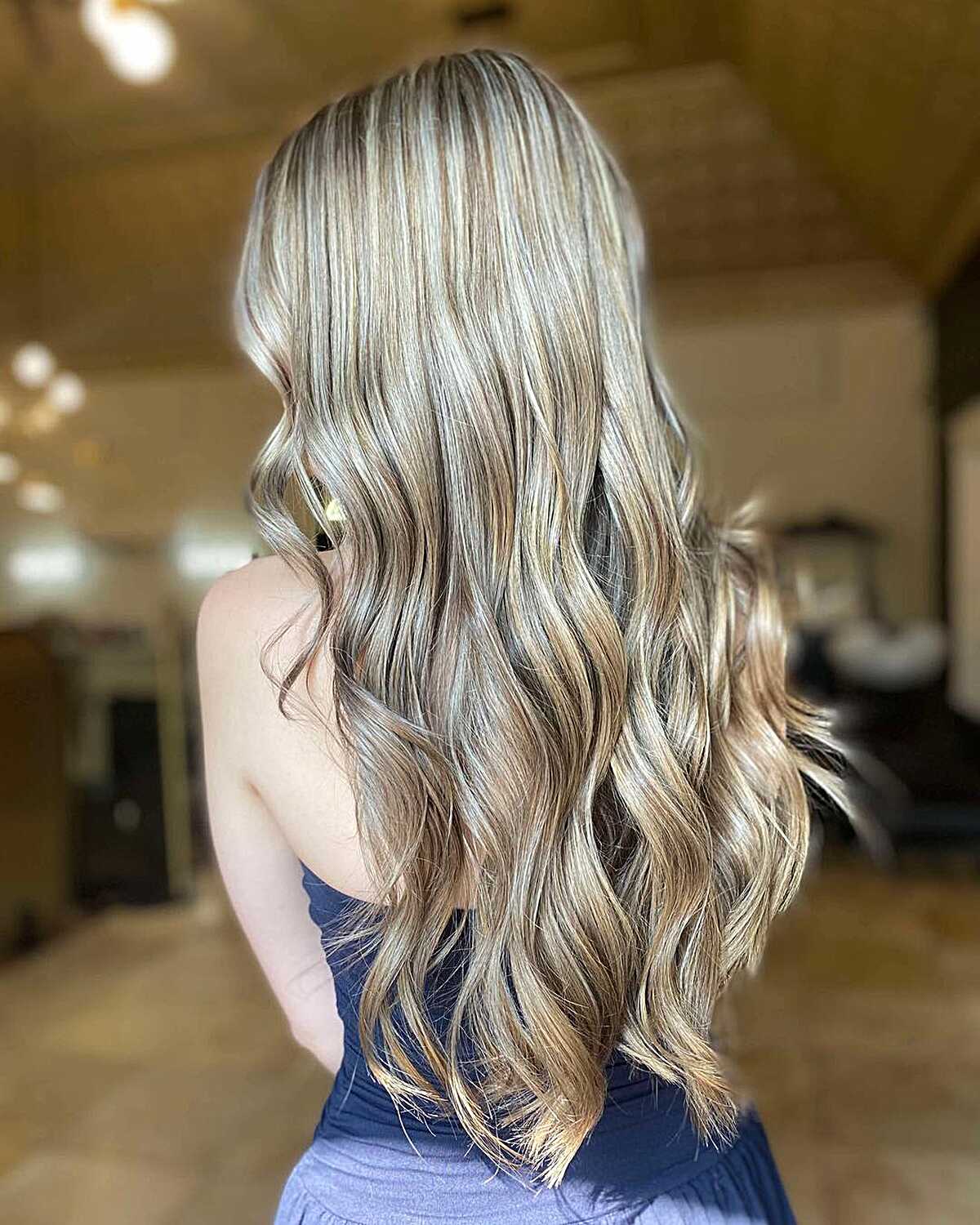 Long bronde hair with multi-tonal highlights and loose curls