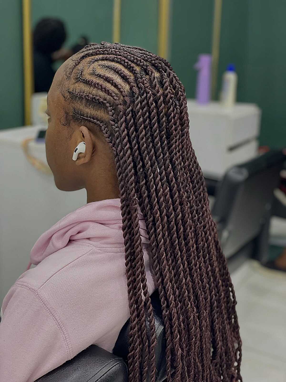 Dark burgundy cornrow base flowing into long twists