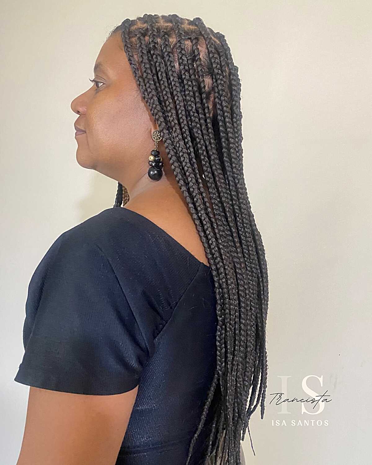 Side profile of jet black medium knotless box braids